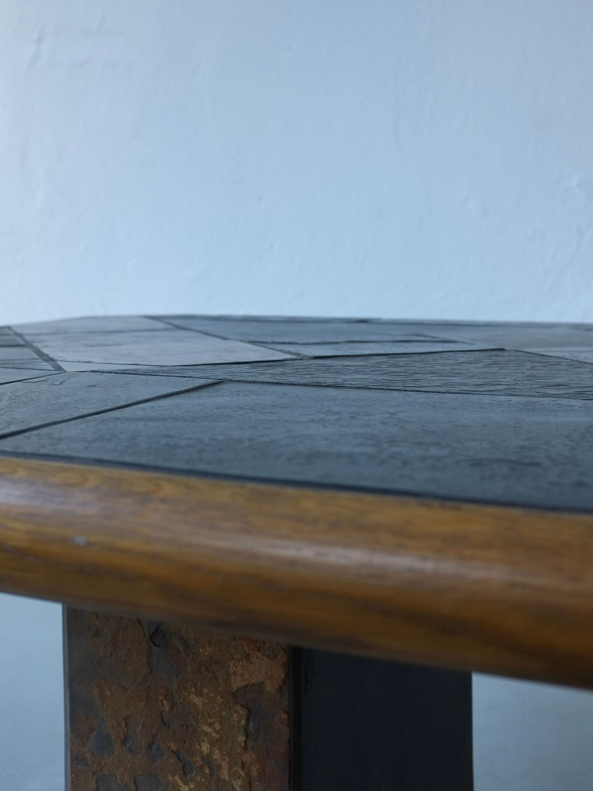Close-up detail of slate stone tabletop on oak coffee table base