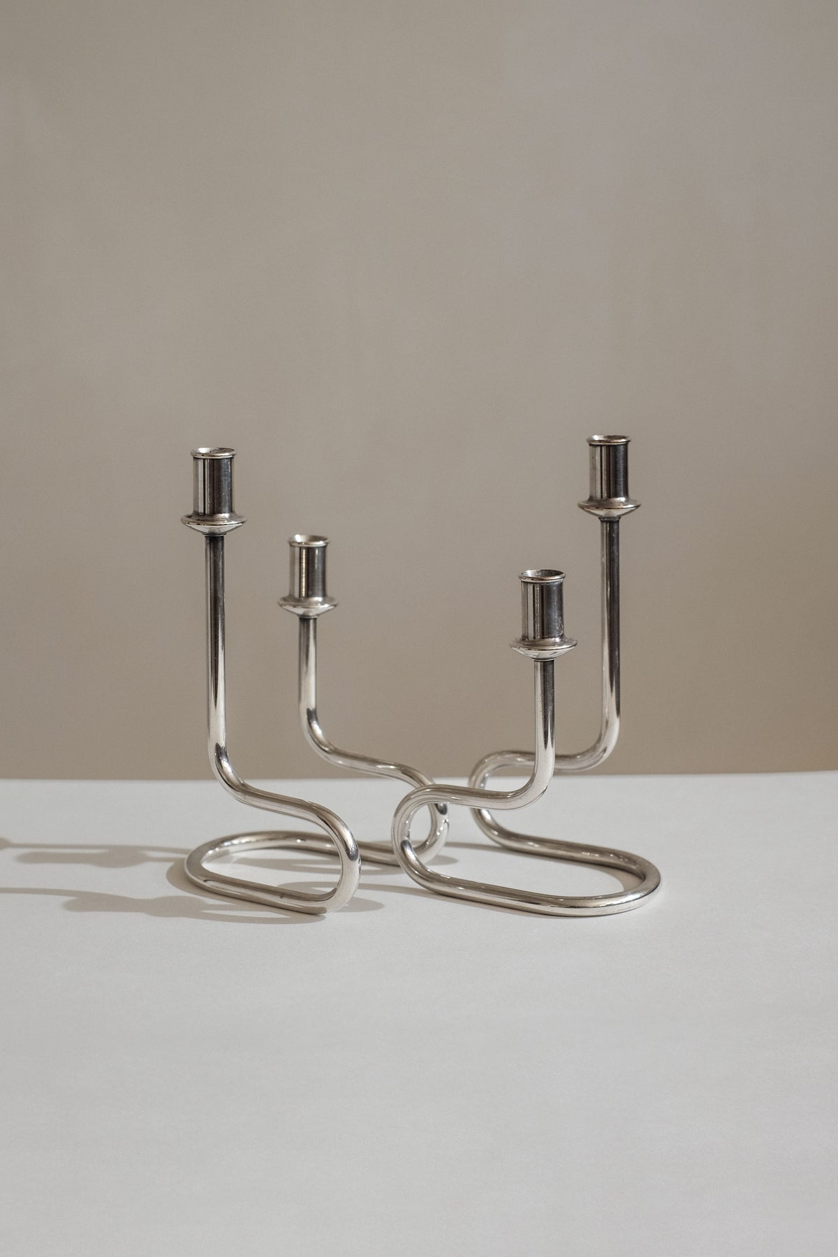 Modern silver-plated Italian candelabra with curved sculptural base