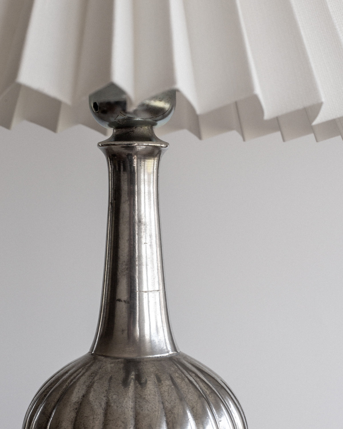 Pewter table lamp base detail showing Art Deco fluted design