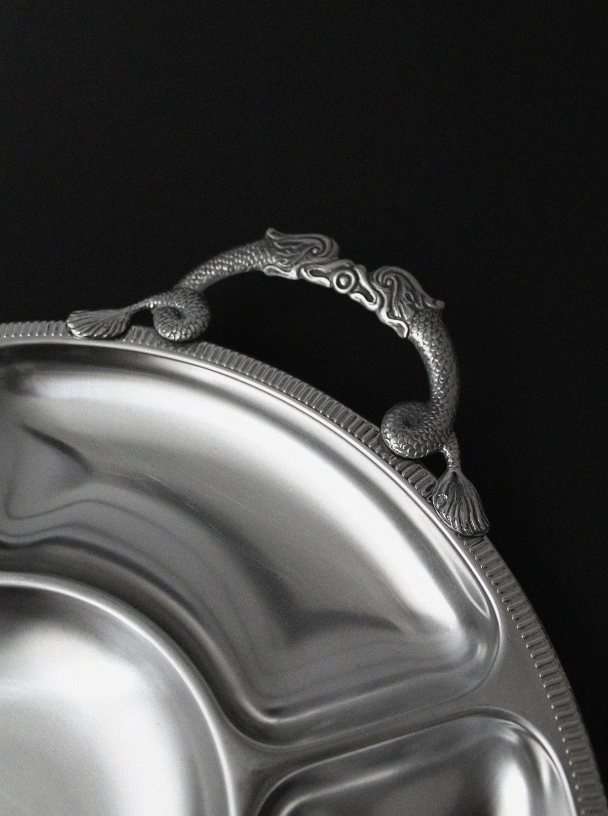 Dragon-detailed handle on brushed stainless steel serving piece