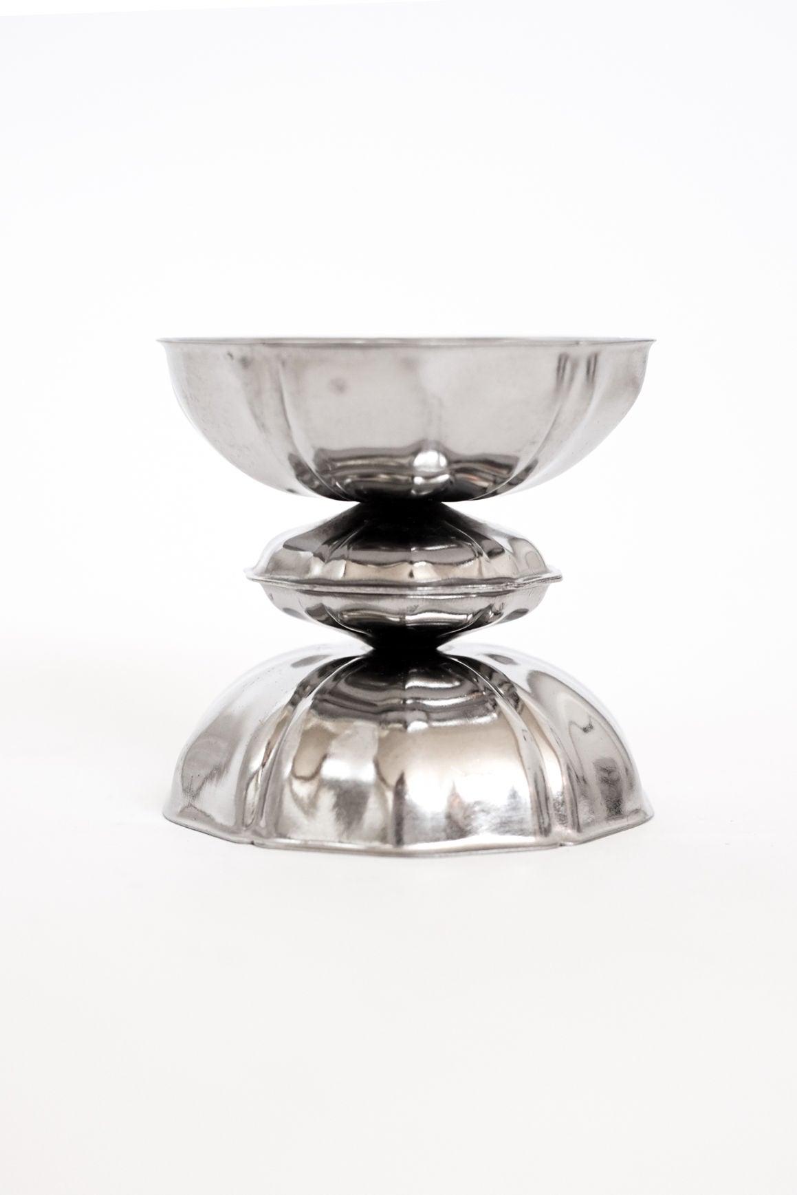 Stacked silver ice coupes showing elegant curved profile design