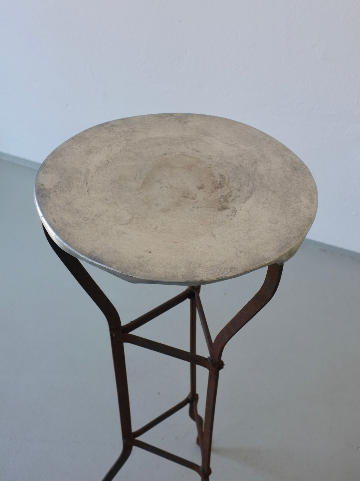 Round travertine top detail of vintage iron pedestal side table