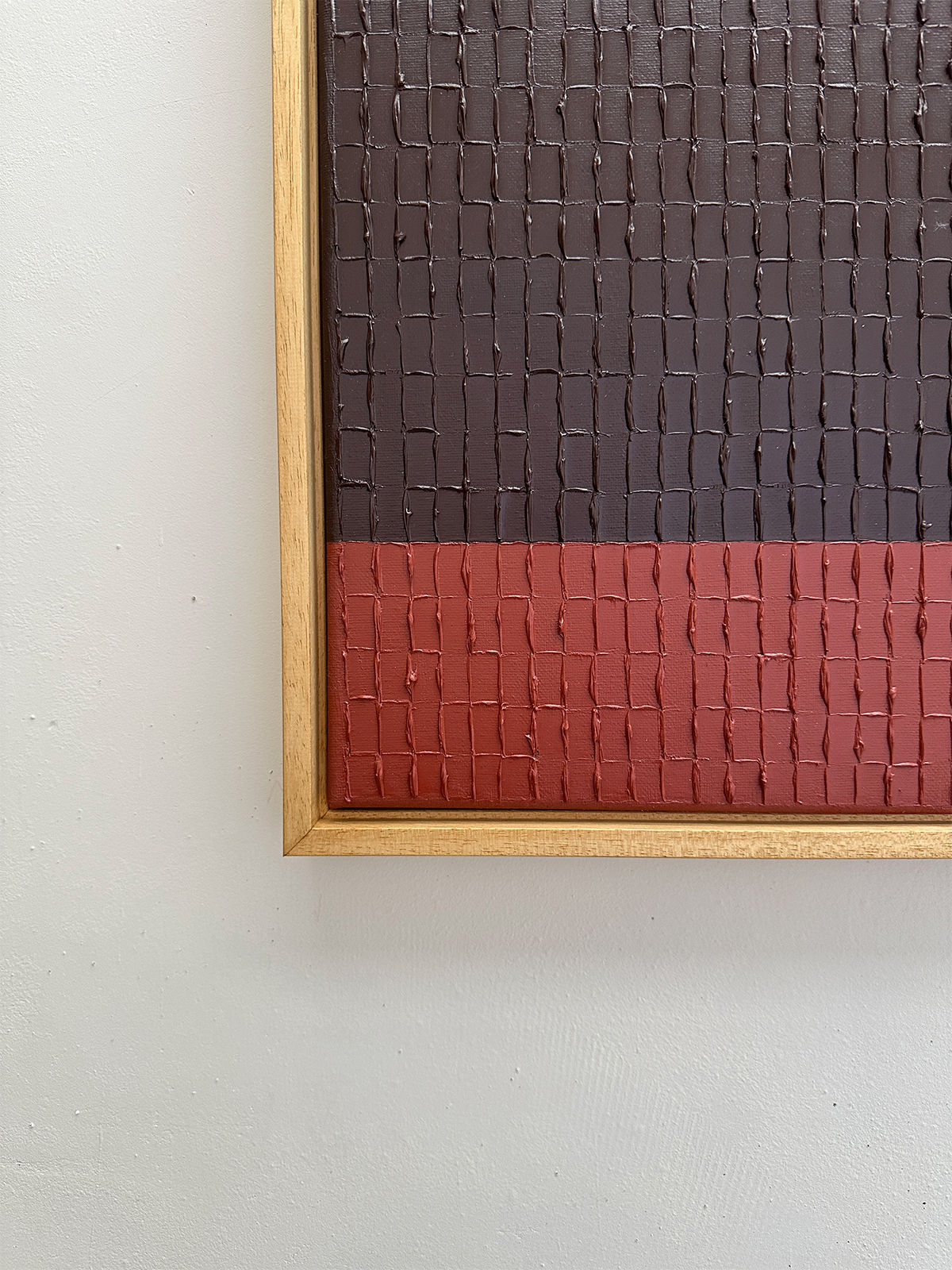 Detail view of textured Indian Red Mud painting with grid pattern