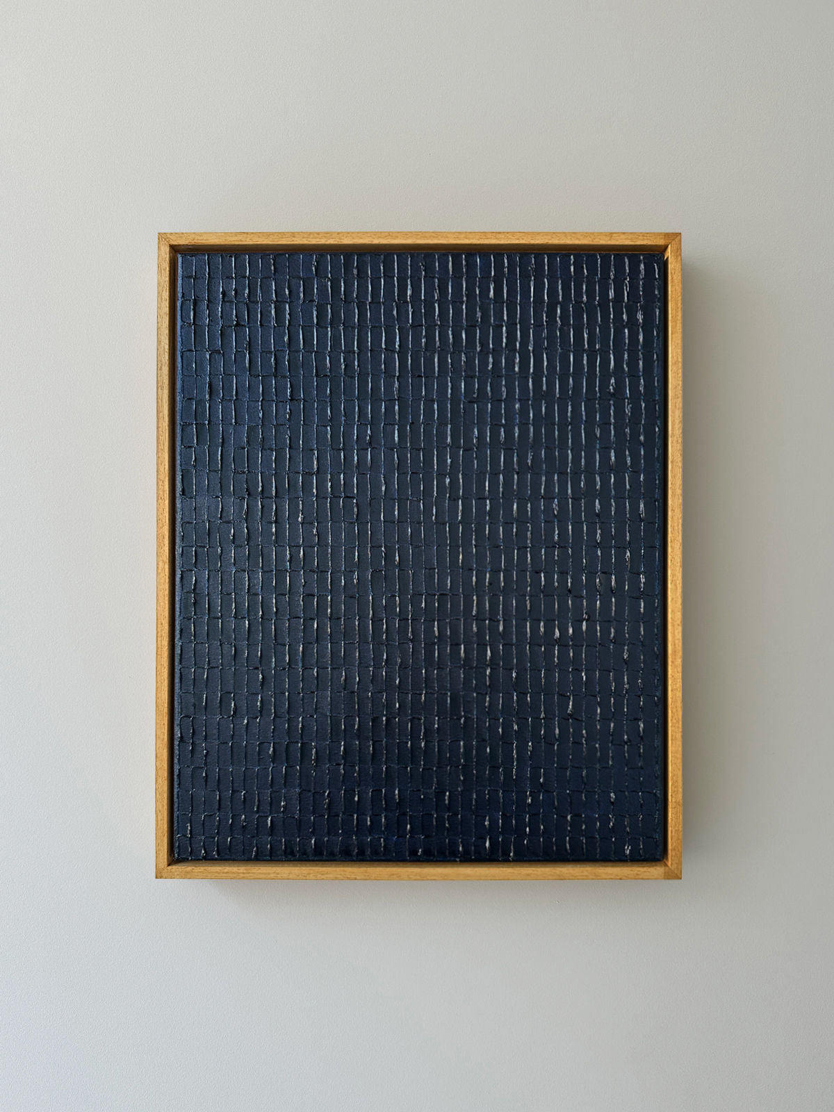 Prussian blue textured abstract painting in wooden frame by Roi Elmaliah