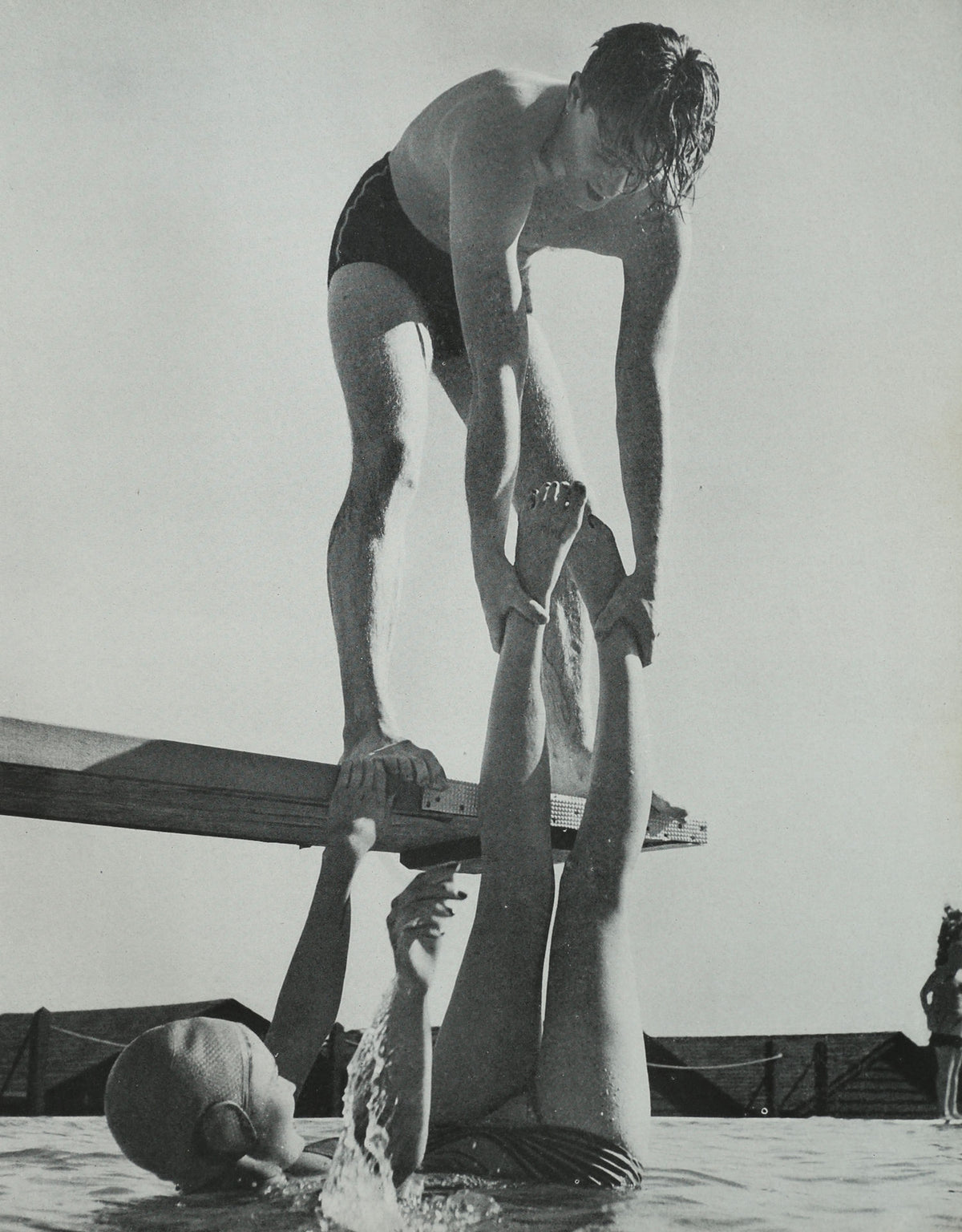 Black and white vintage swimmers on diving platform photography