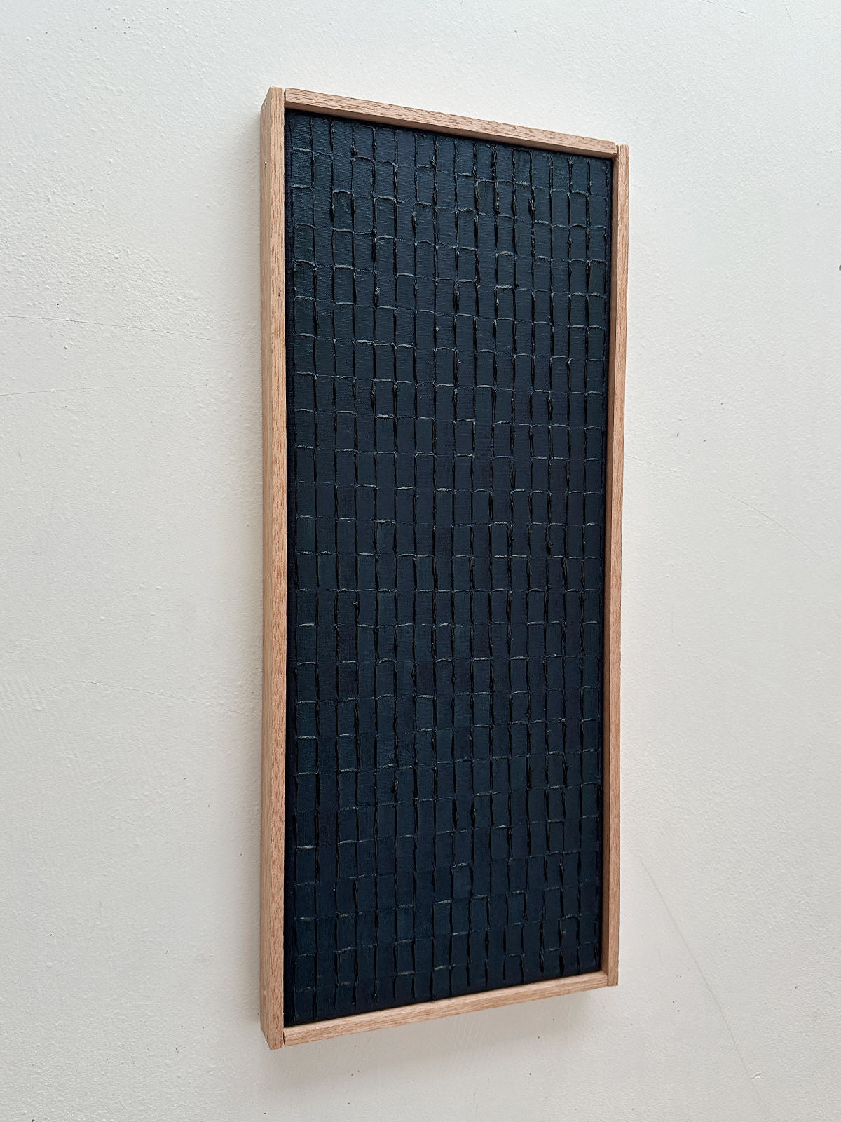 Prussian blue textured painting with charred wood mosaic pattern