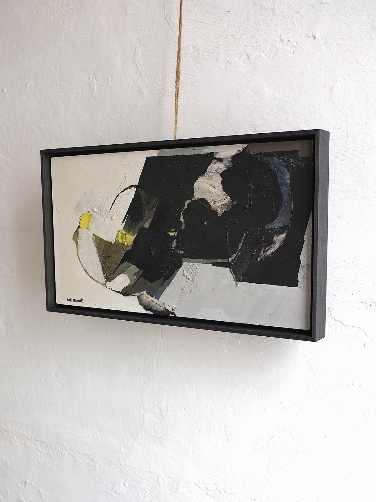 The Abstract Oil Painting by Hans Osswald, Sweden 1950s from Veter Vintage features bold black, white, gray shapes with a touch of yellow and hangs on a textured white wall by twine—a striking mid-century statement piece.