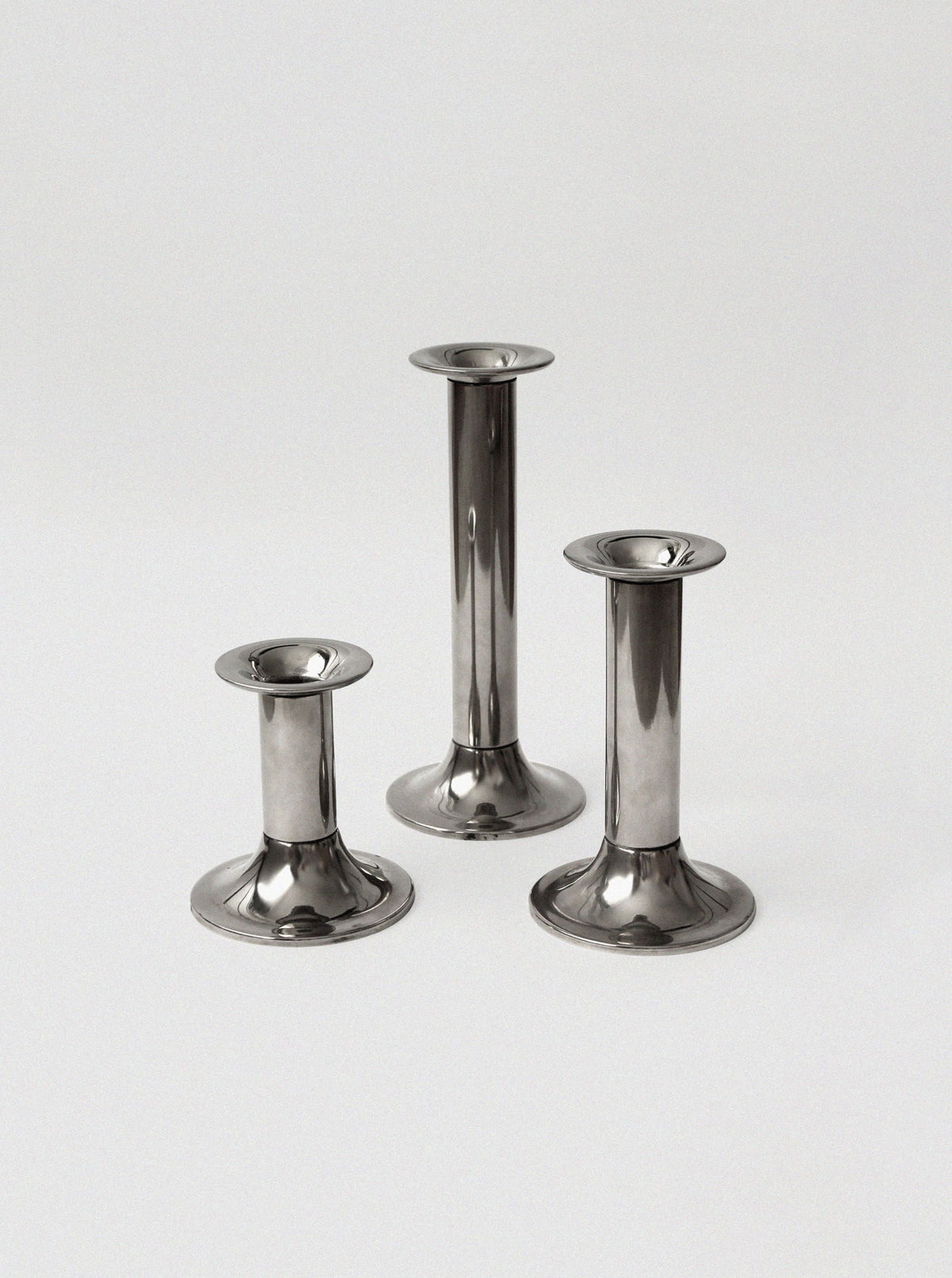 Three silver plated vintage candle holders in graduated heights
