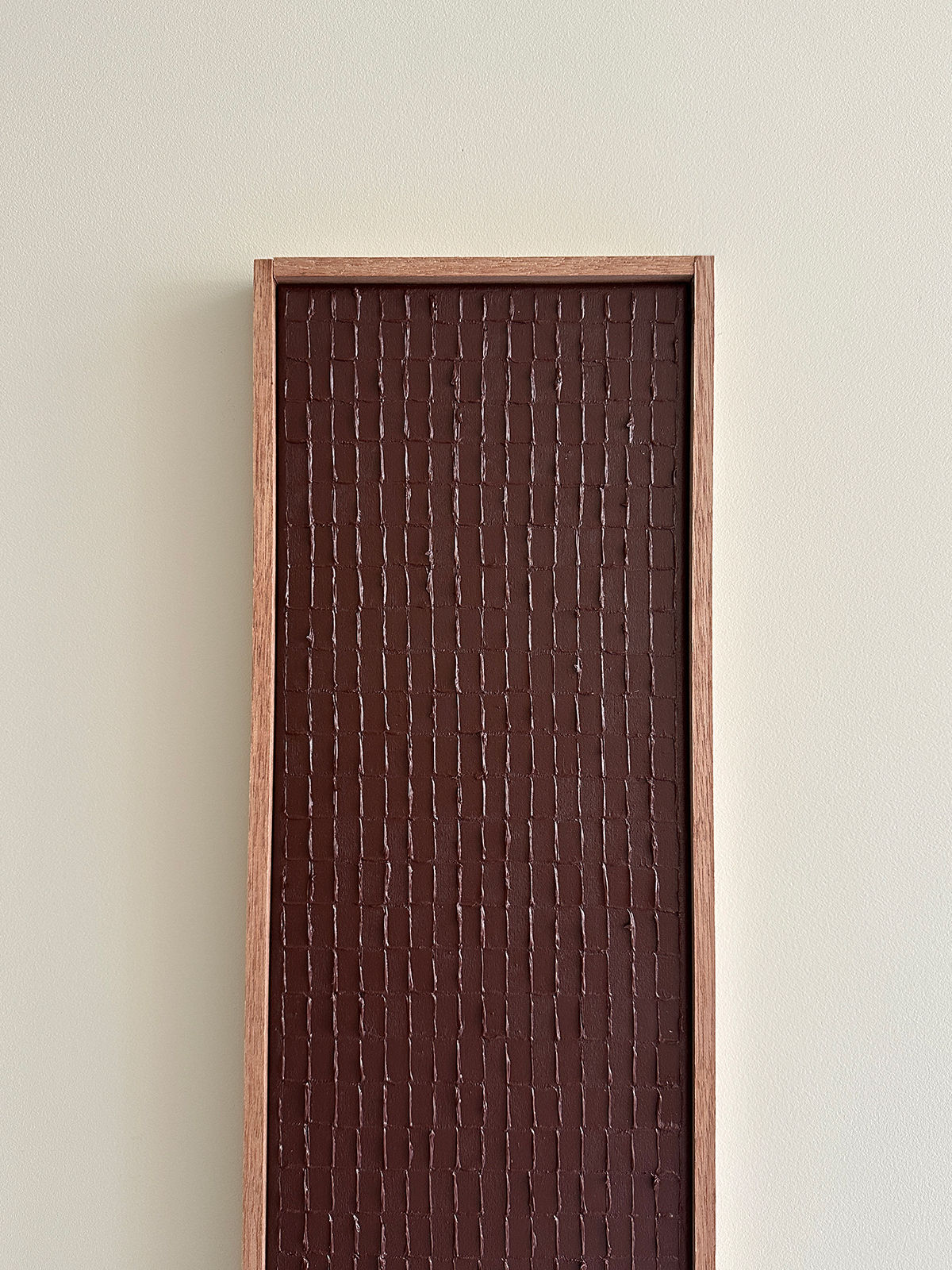 Indian mud textural painting with organic vertical lines in wooden frame