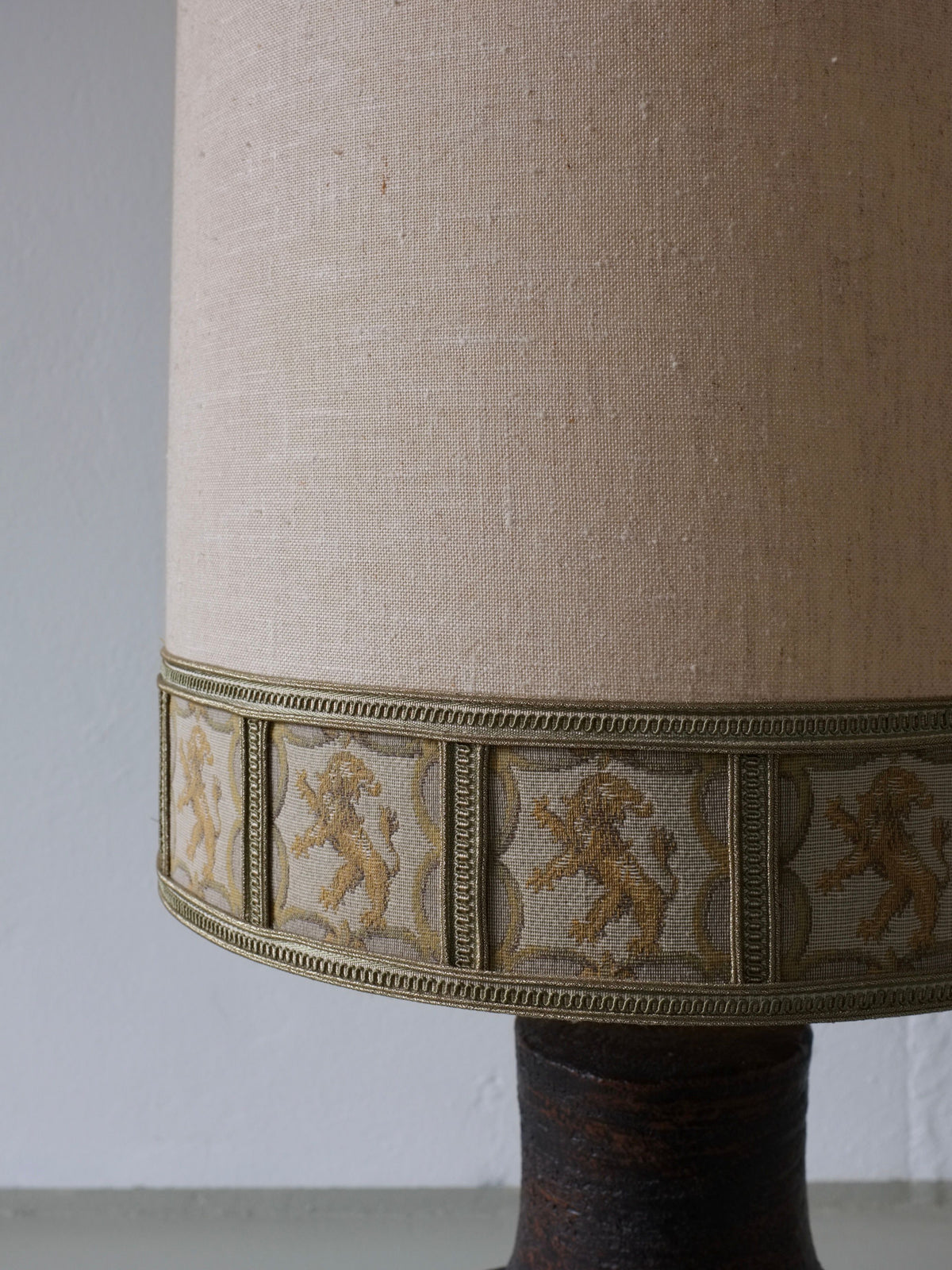 Brutalist ceramic lamp detail showing decorative band with figurative motifs