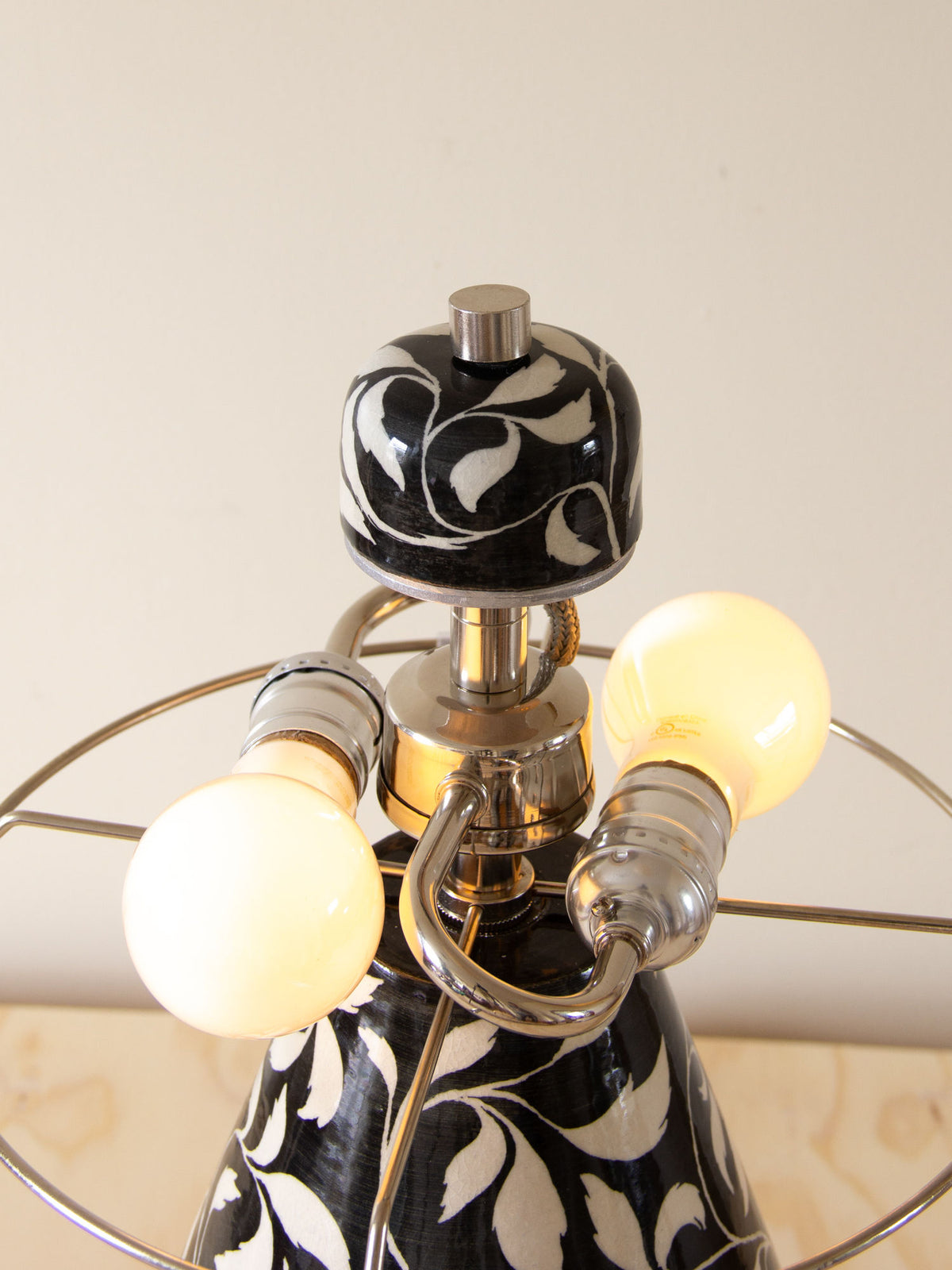 Close-up detail of Paisley table lamp's marbled ceramic base with brass fittings