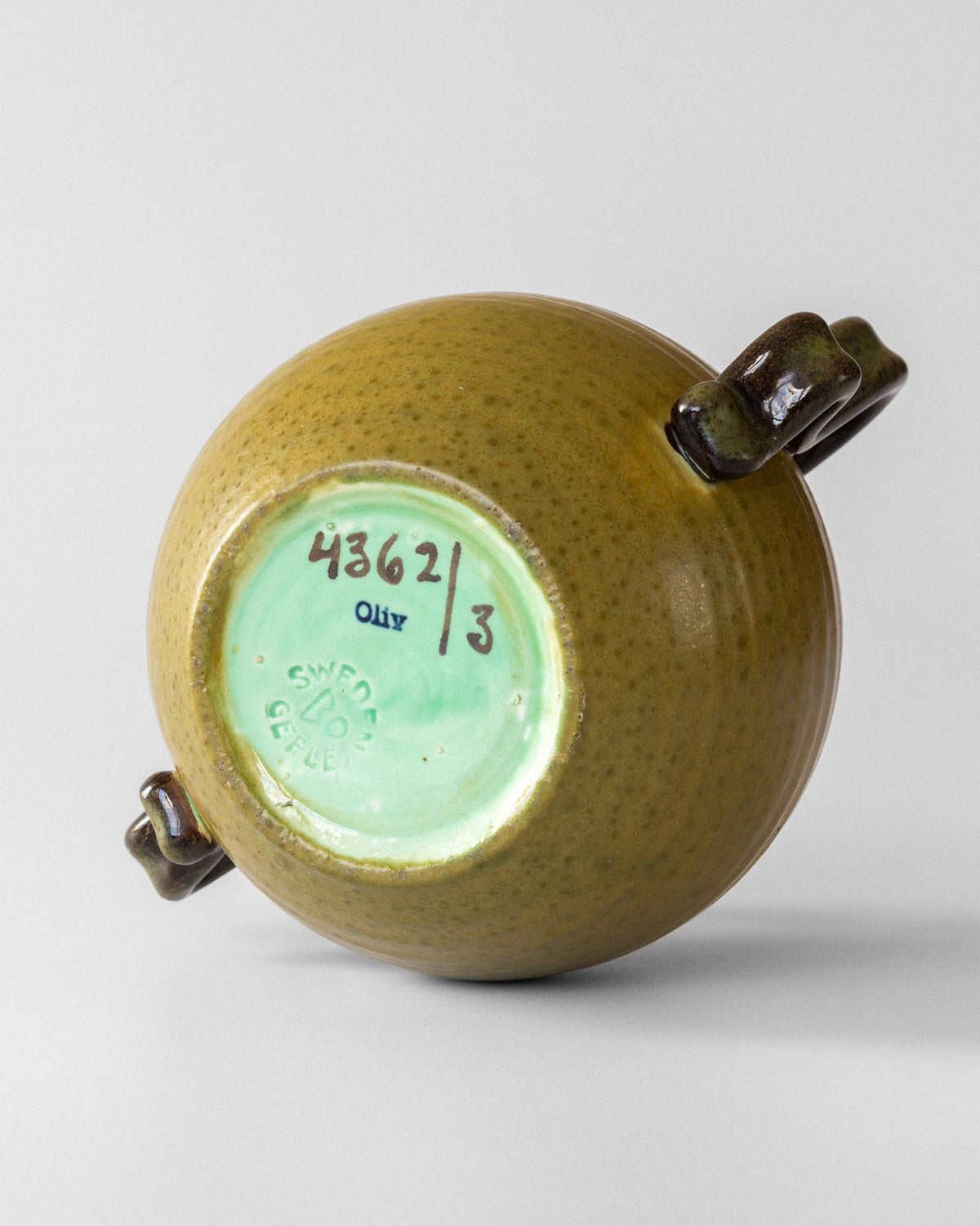 Bottom view showing maker's mark and numbering of Oliv ceramic vase