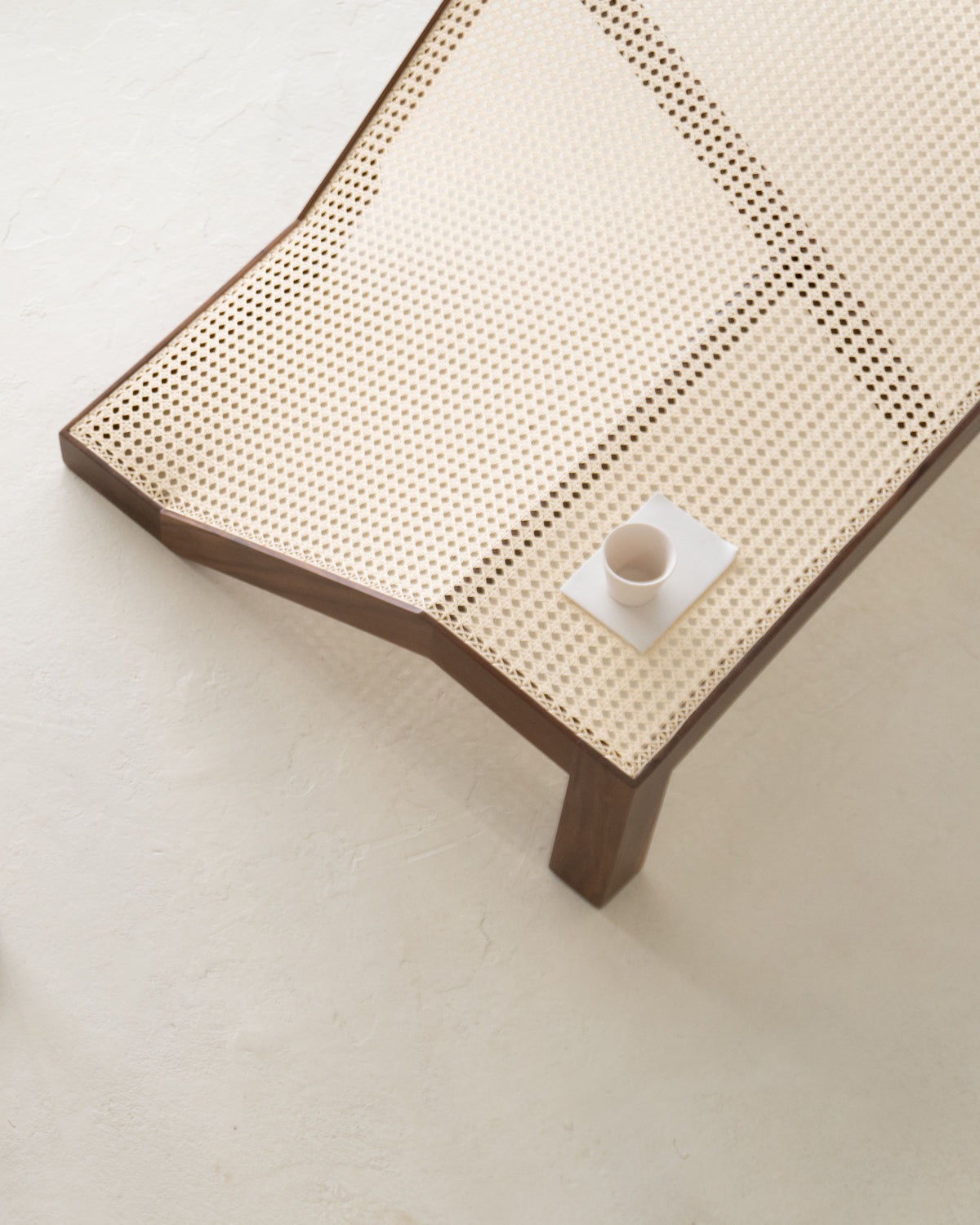 Cabana center table with woven cane top and ceramic cup detail