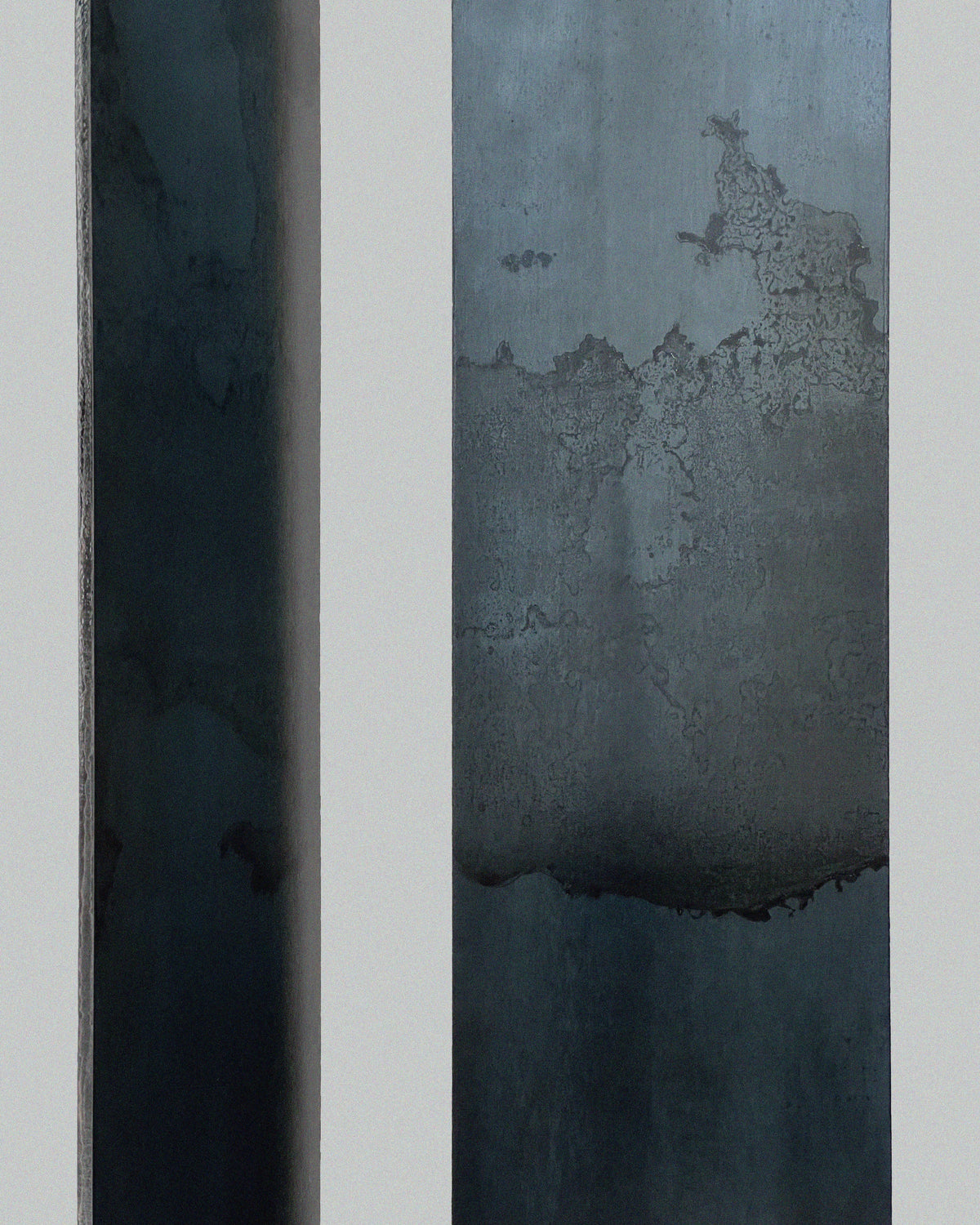 Close-up steel surface detail of Hiro console showing patina texture