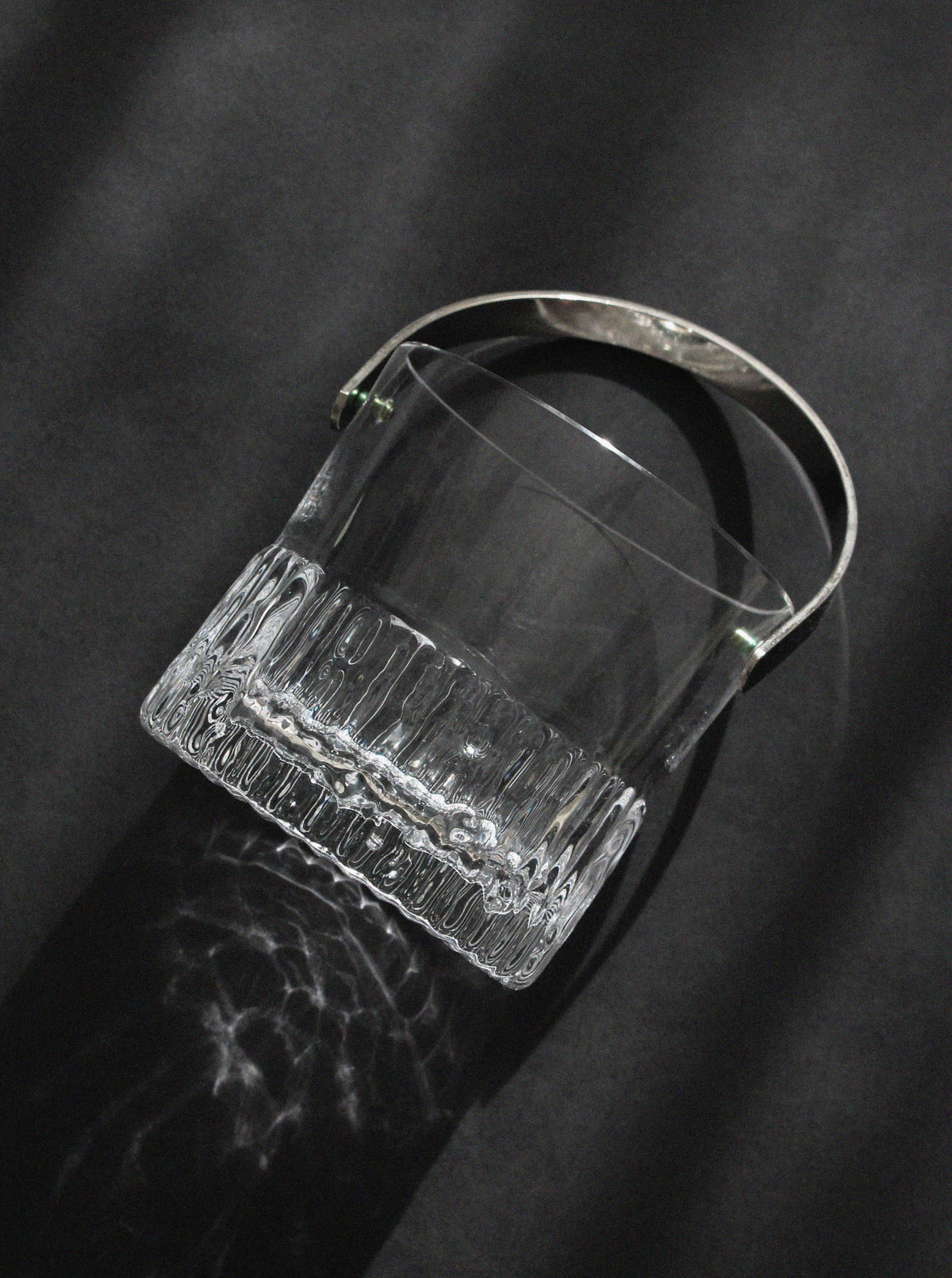 Crystal ice bucket with ribbed base detail and curved handle by Göran Wärff