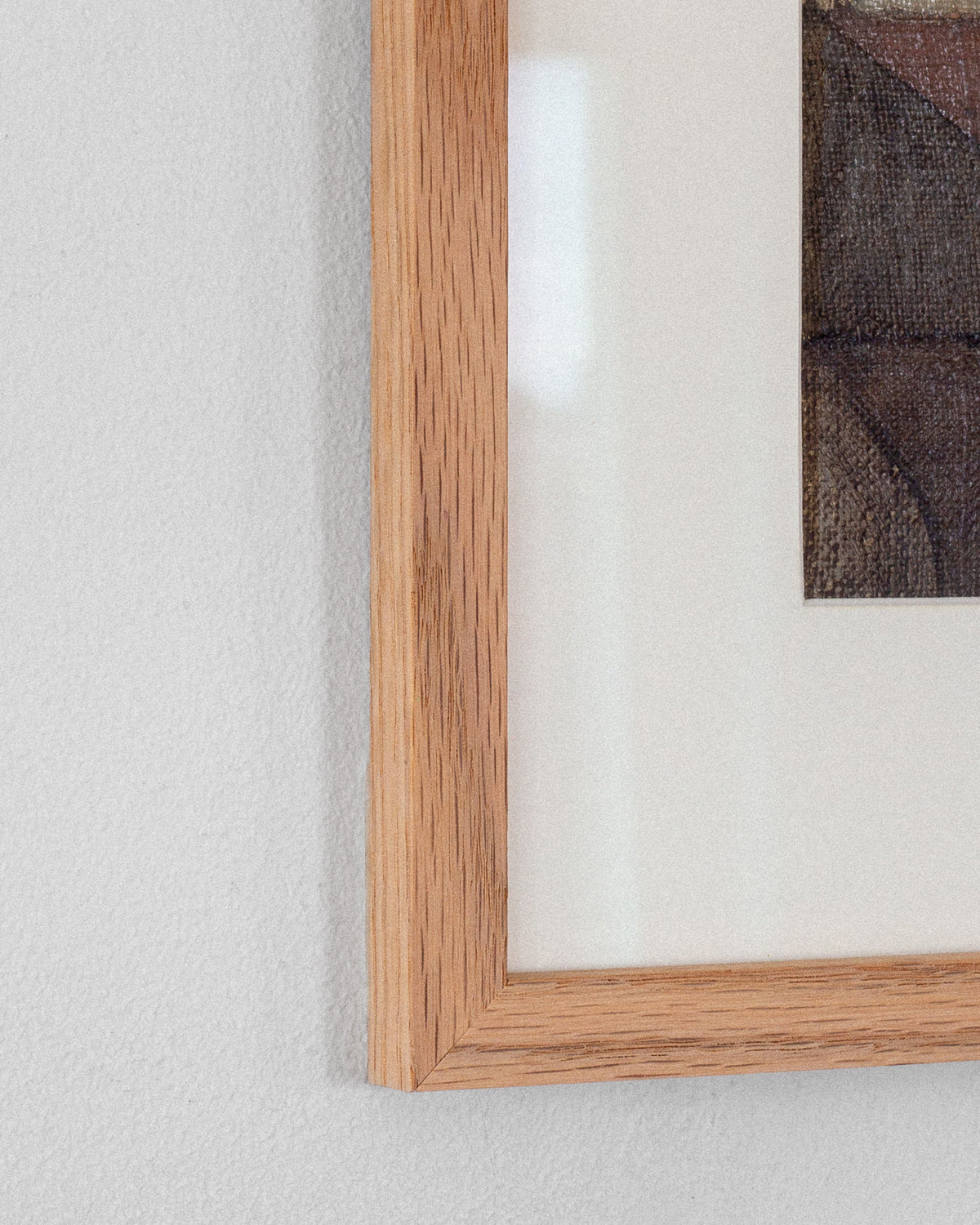 Close-up of a Spigel wooden picture frame on a textured white wall, highlighting the corner of the "Abstract Oil Painting by Carl Riise, Sweden 1970s," featuring muted colors and a cubist-inspired style.