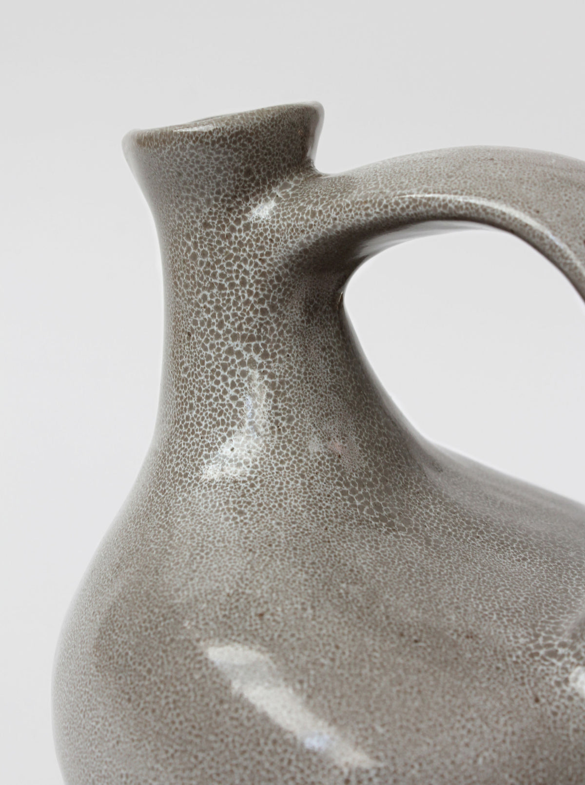 Close-up spout and handle detail of mid-century ceramic grey jug