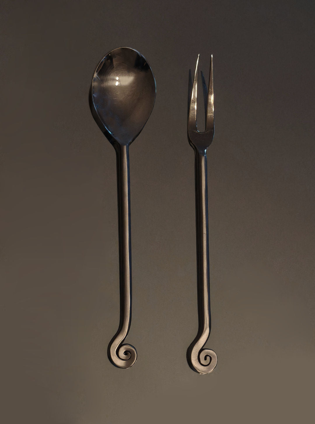 Stainless steel serving spoon and fork with spiral handle detail