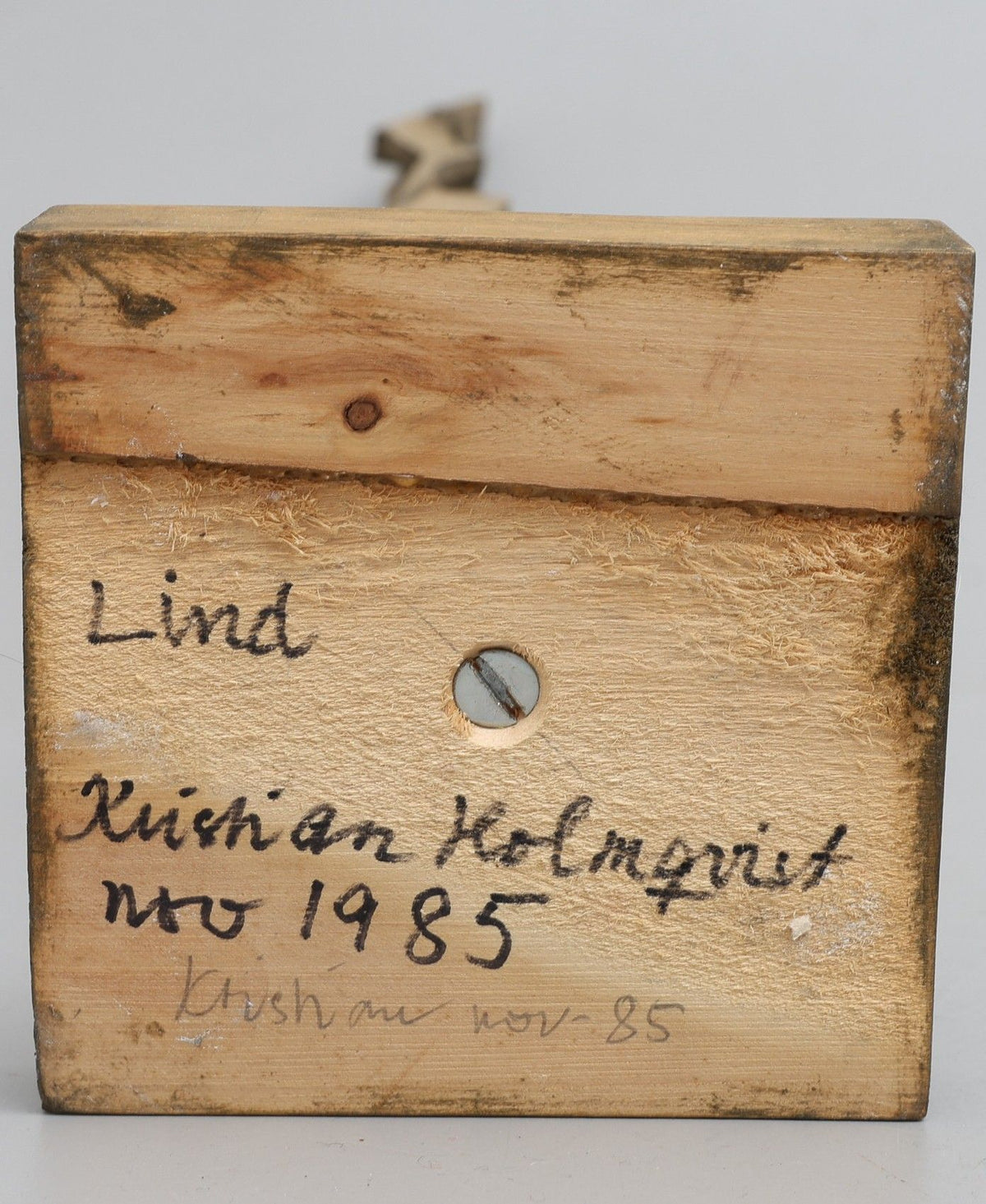 Wooden sculpture block with carved text detail by Kristian Holmqvist