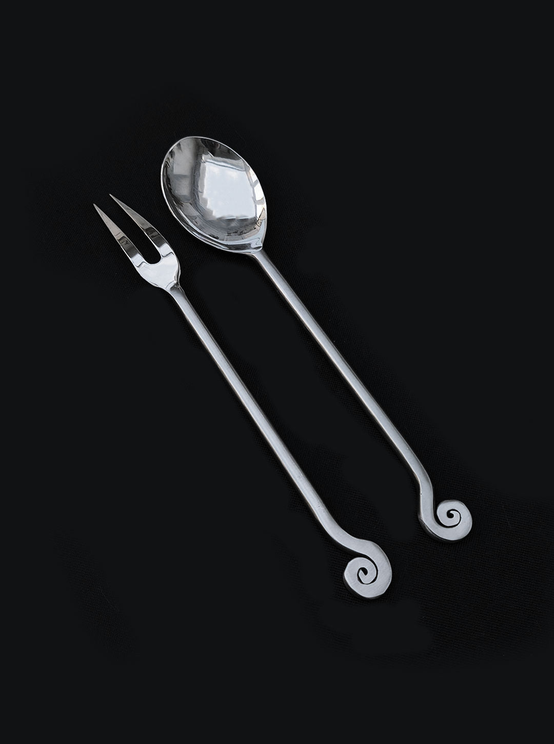 Spiral-handled serving spoon and fork cutlery set detail view