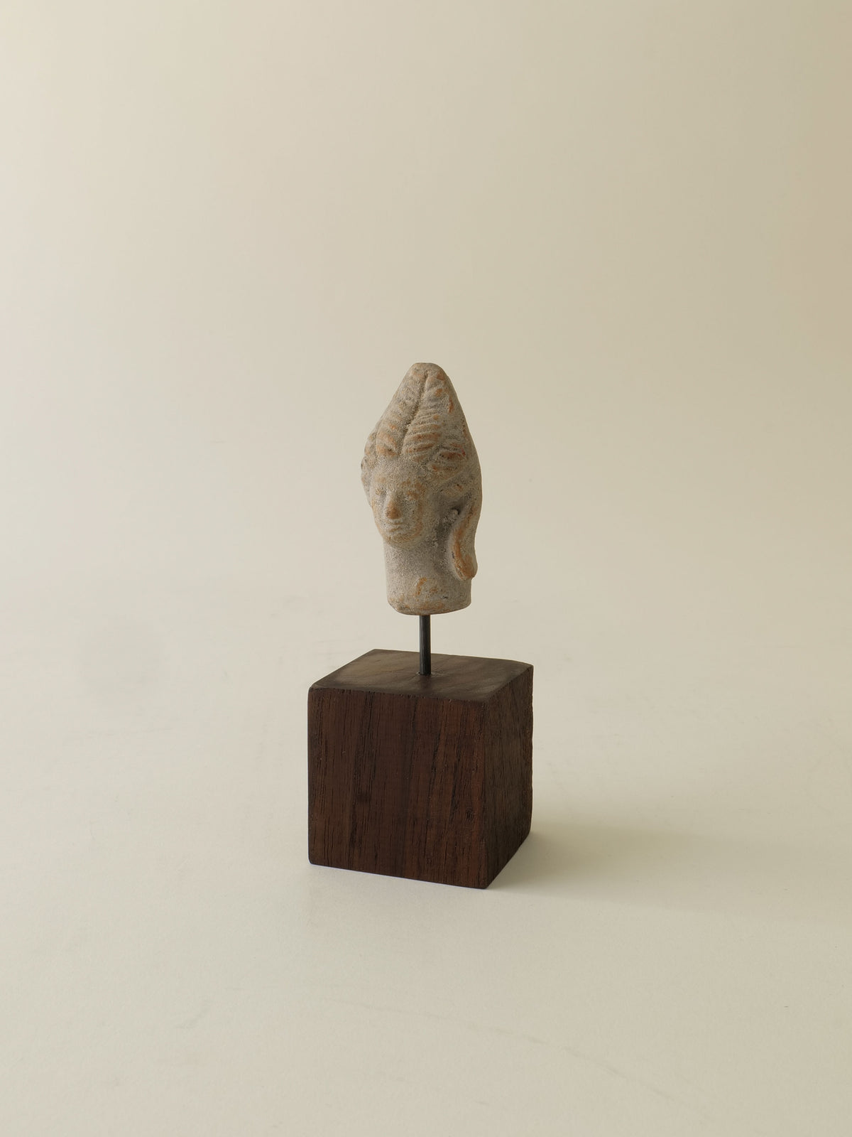 Ancient stone Hera sculpture head mounted on dark wooden base