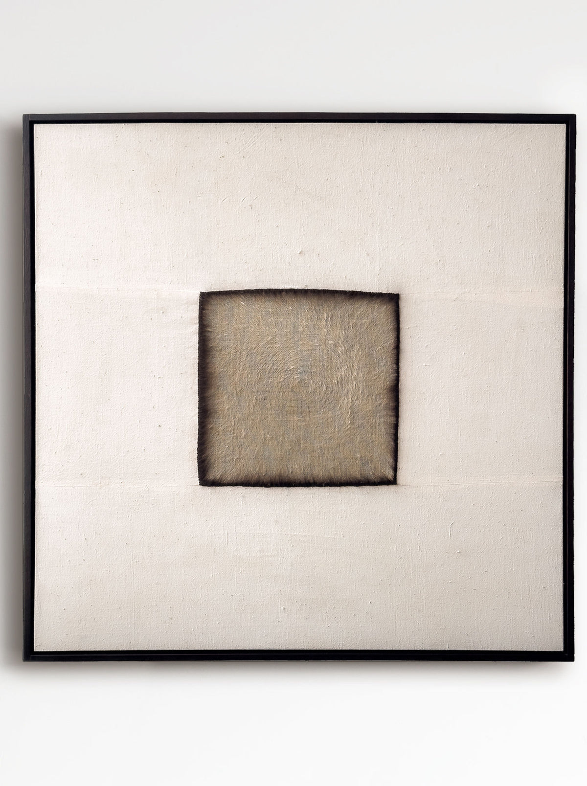 Charred," a minimalist artwork by Bec Kirby (2025), showcases a textured, frayed dark-edged square on an off-white square canvas. Elegantly framed in solid oak, it combines warmth and sophistication.