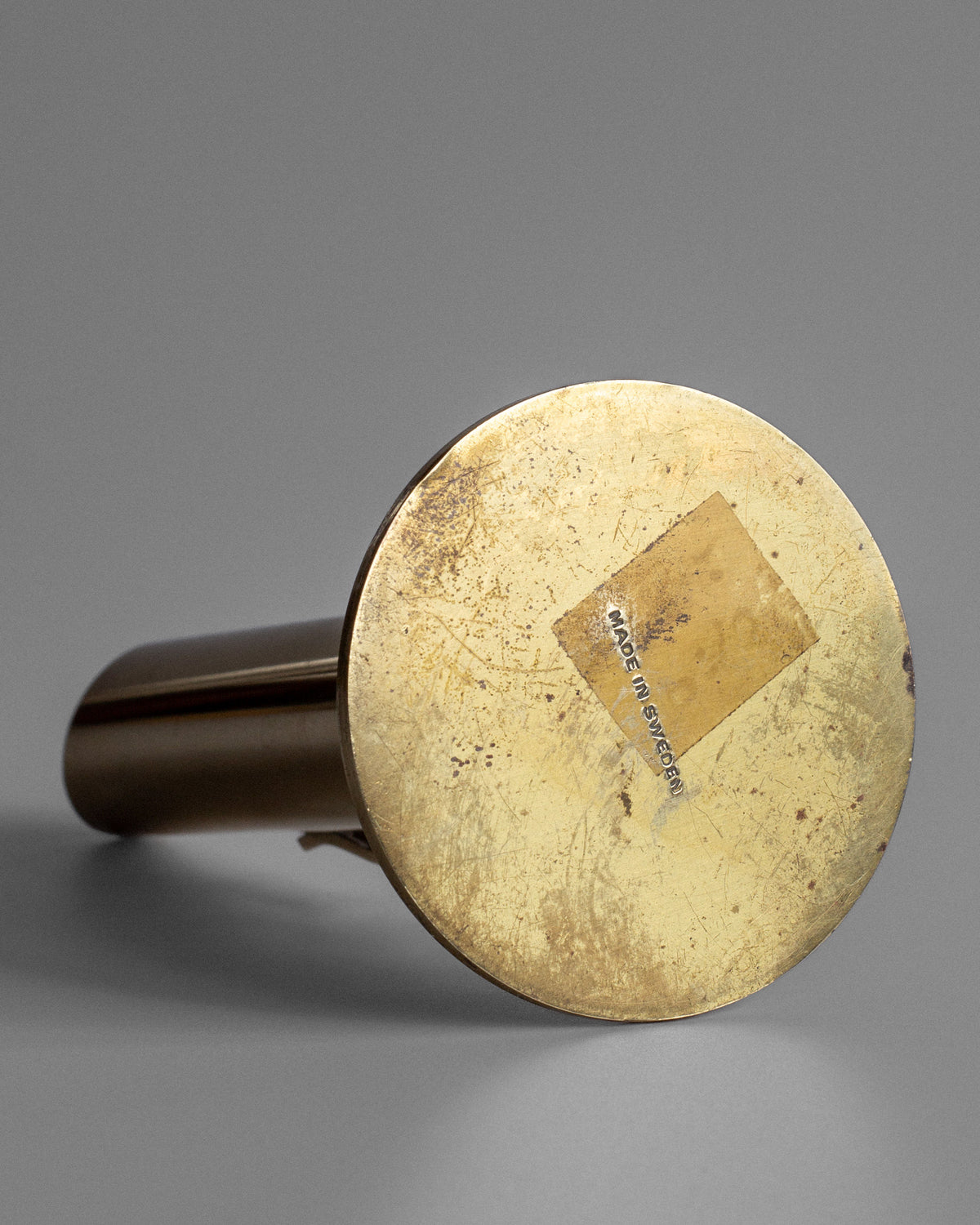 Bottom view of mid-century brass vase showing maker's mark detail