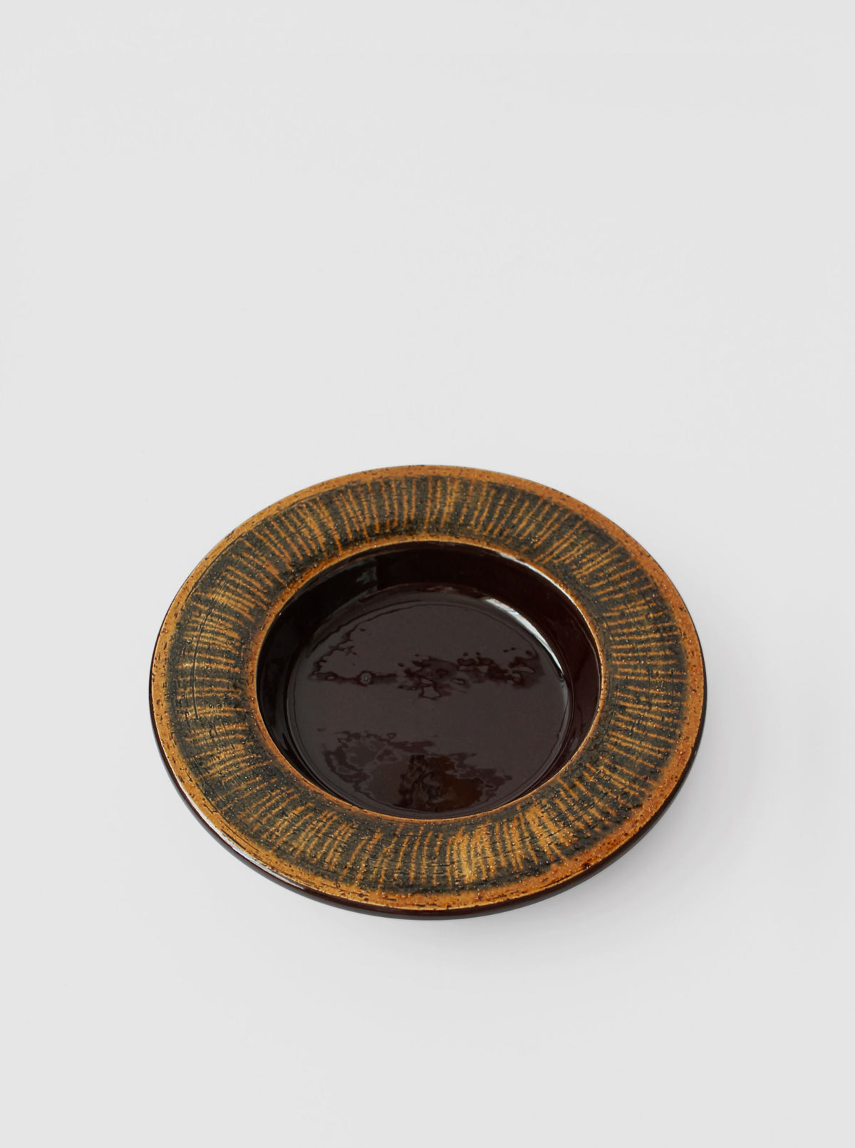 Gabriel Sweden ceramic plate with dark glaze and textured rim