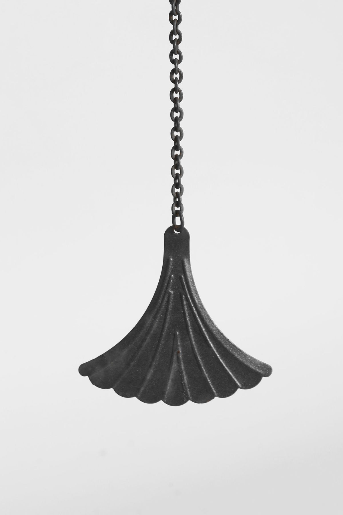 Folk iron windbell pendant with fluted scalloped design on chain