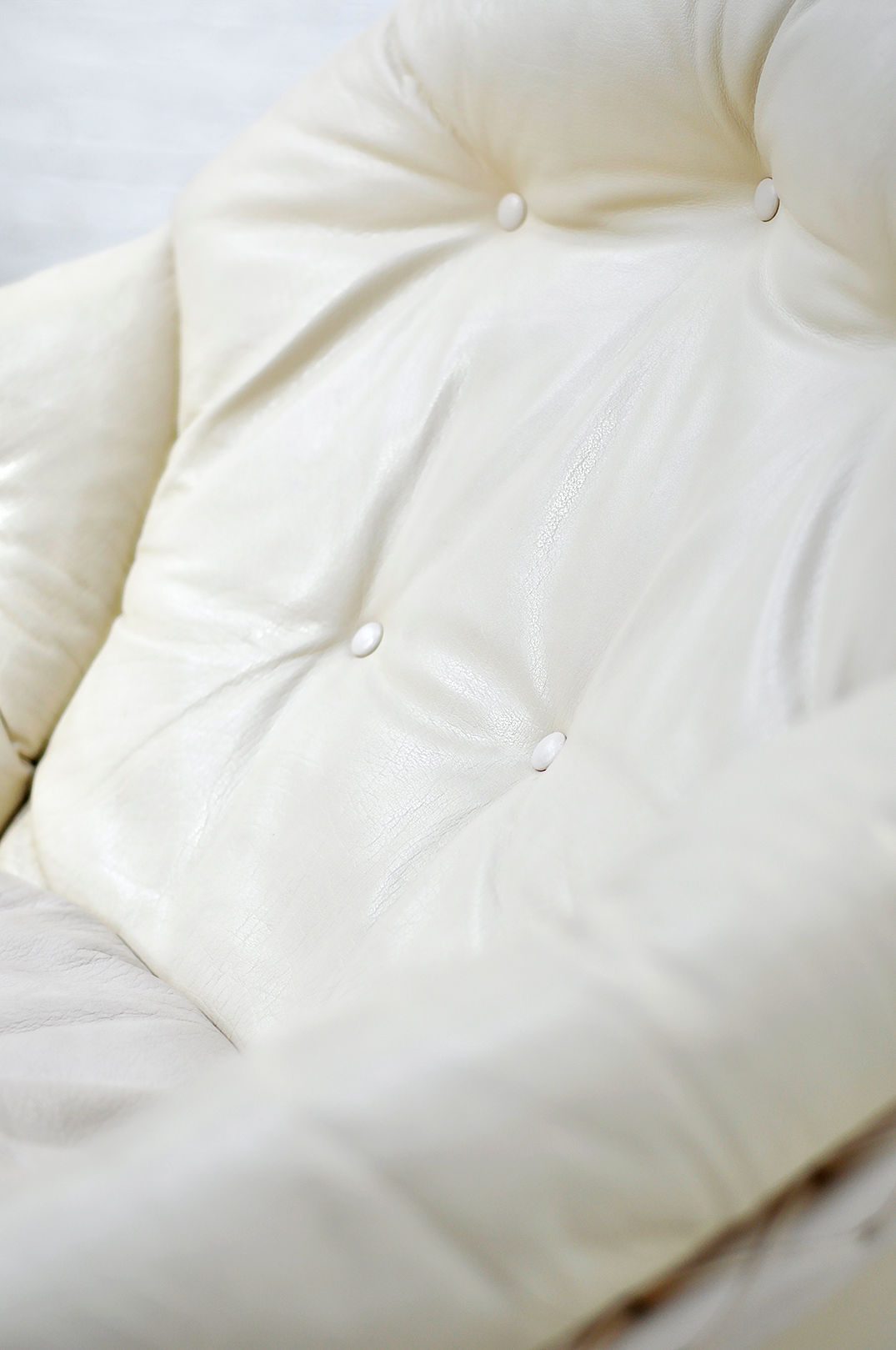 White leather Apollo lounge chair button-tufted upholstery detail