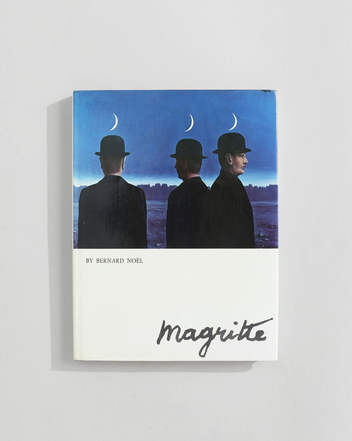 Magritte art book by Bernard Noël featuring surrealist bowler hat men