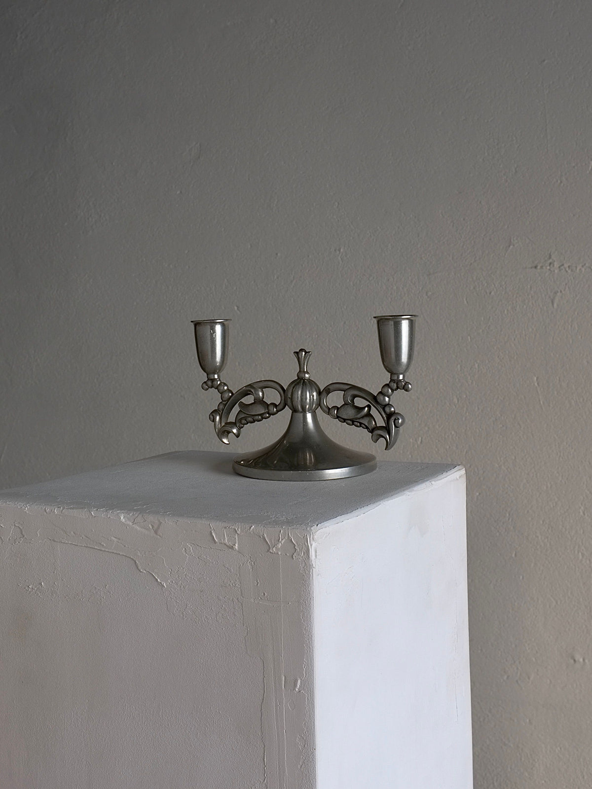 Swedish Grace pewter candleholder with ornate scrollwork arms