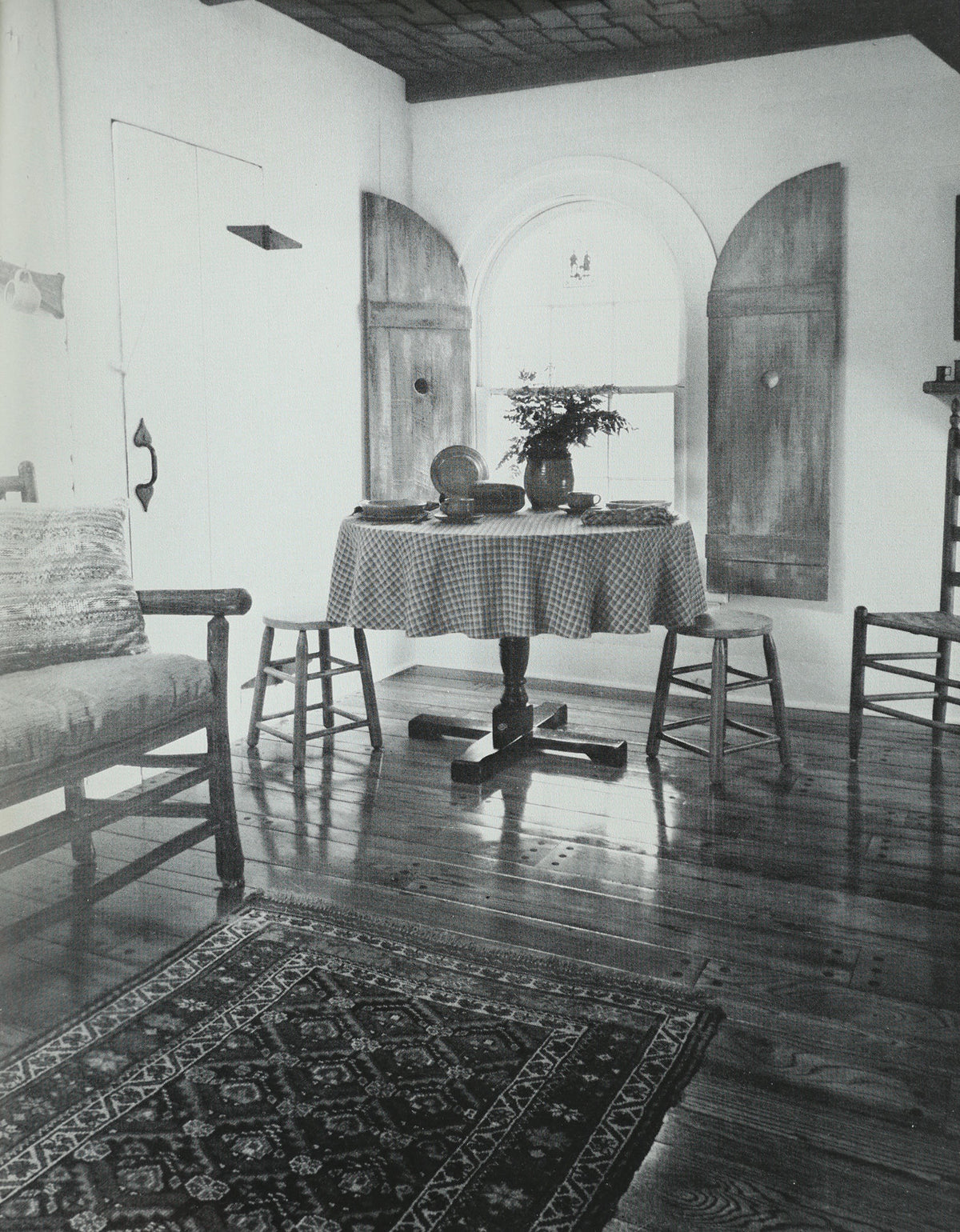 Colonial dining room interior with pedestal table and Windsor chairs