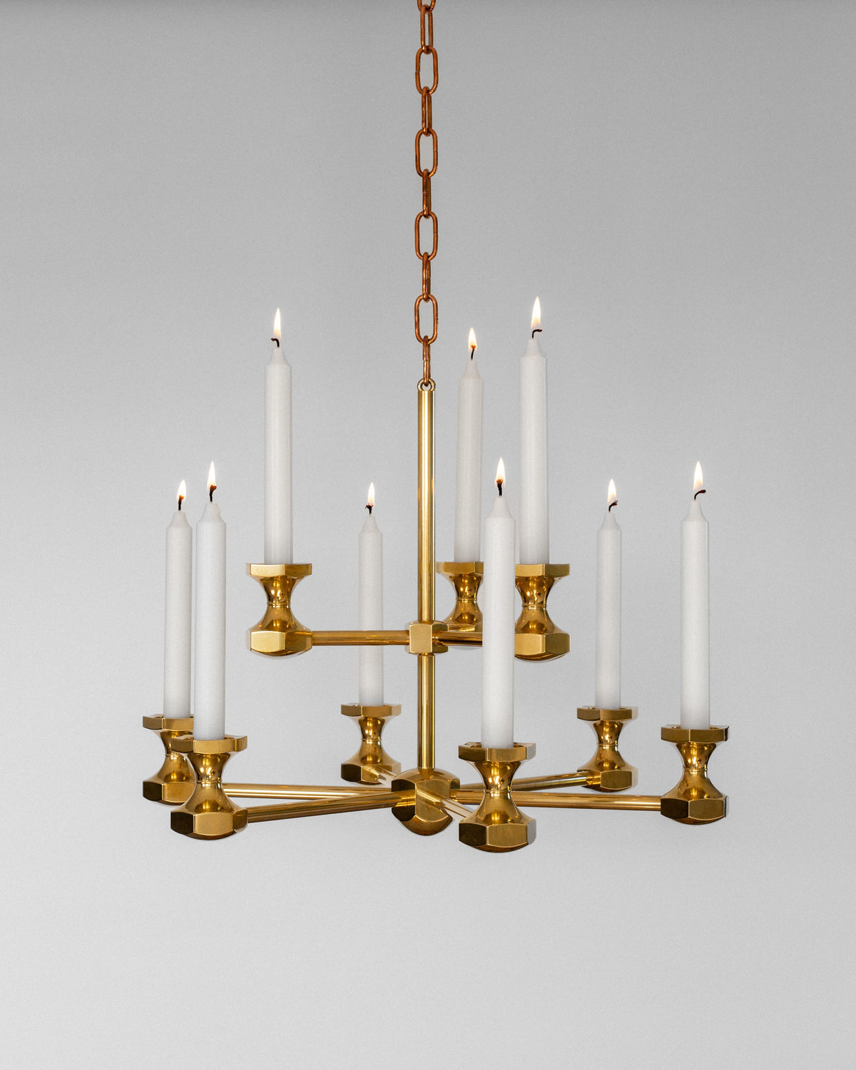 Monumental brass candle chandelier with lit white tapers, 1980s