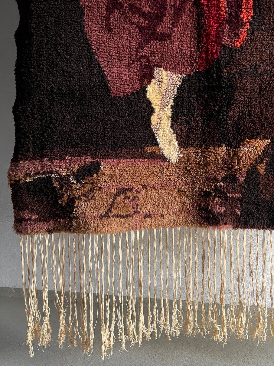 Detail view of fringed edge and textural weave of Swedish wool wall hanging