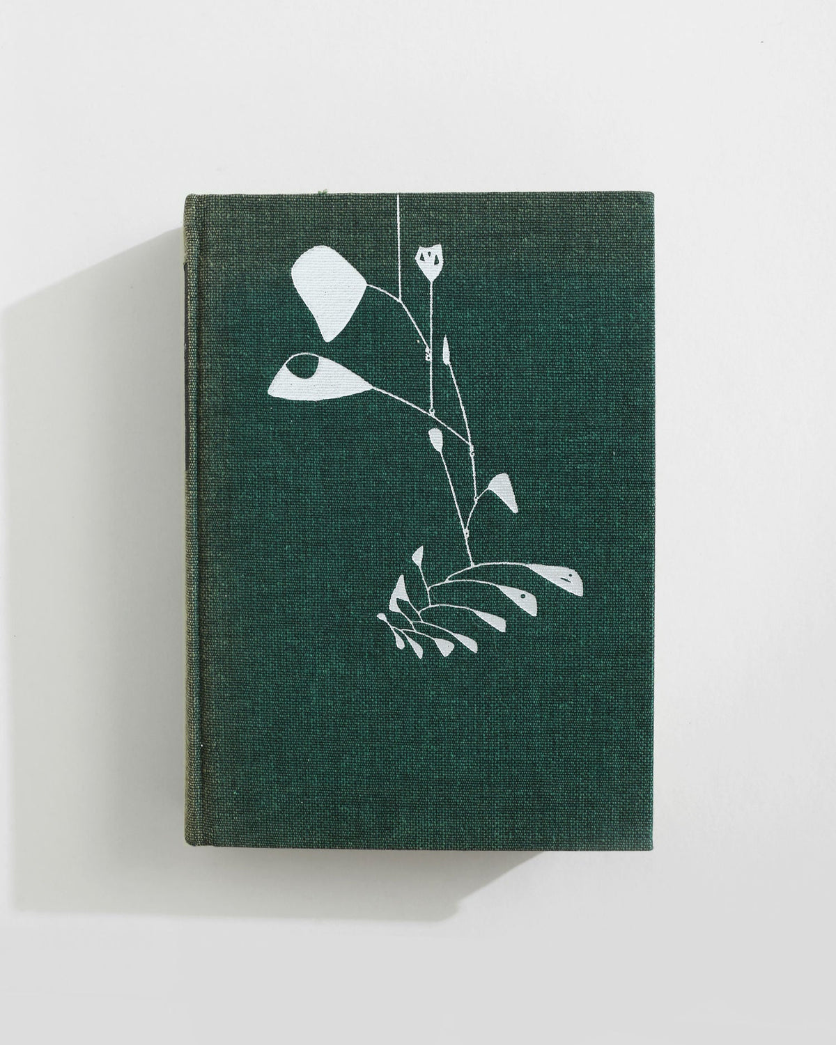 Green cloth-bound American art book with white botanical design