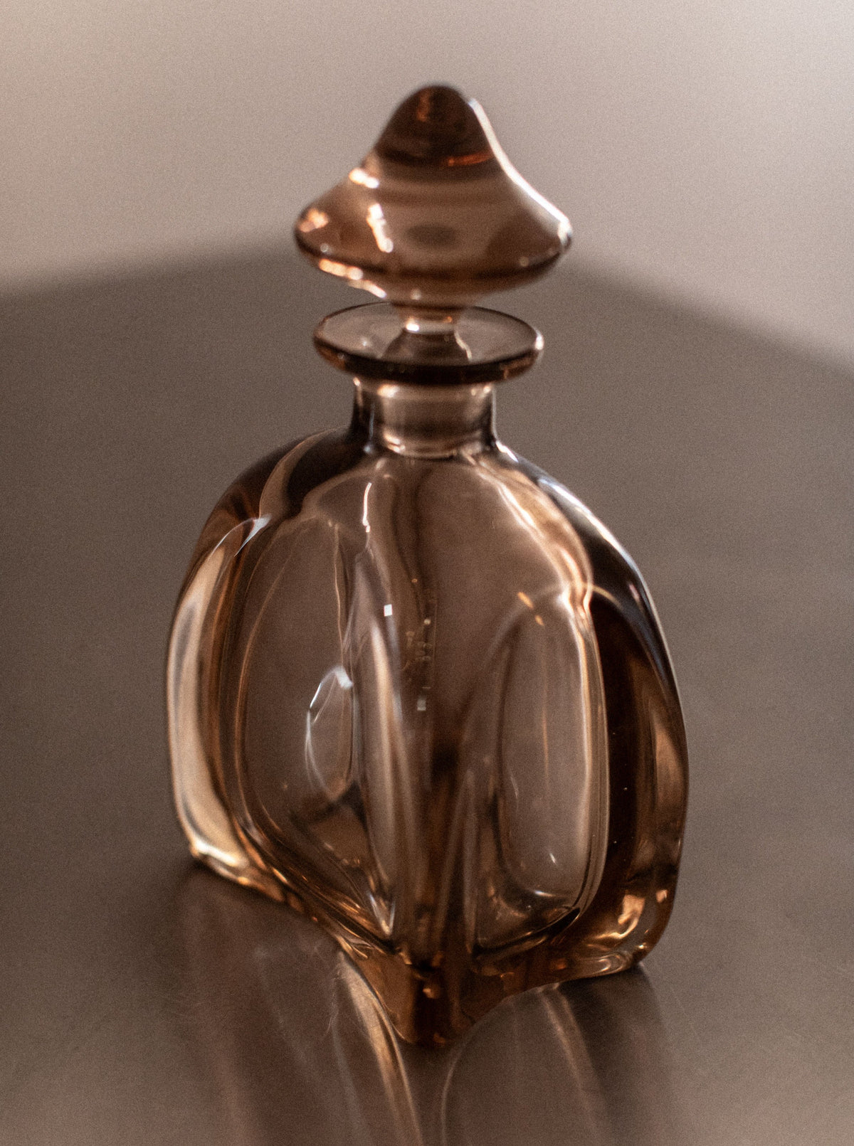 Modern glass decanter with sleek lines and stainless steel pouring spout