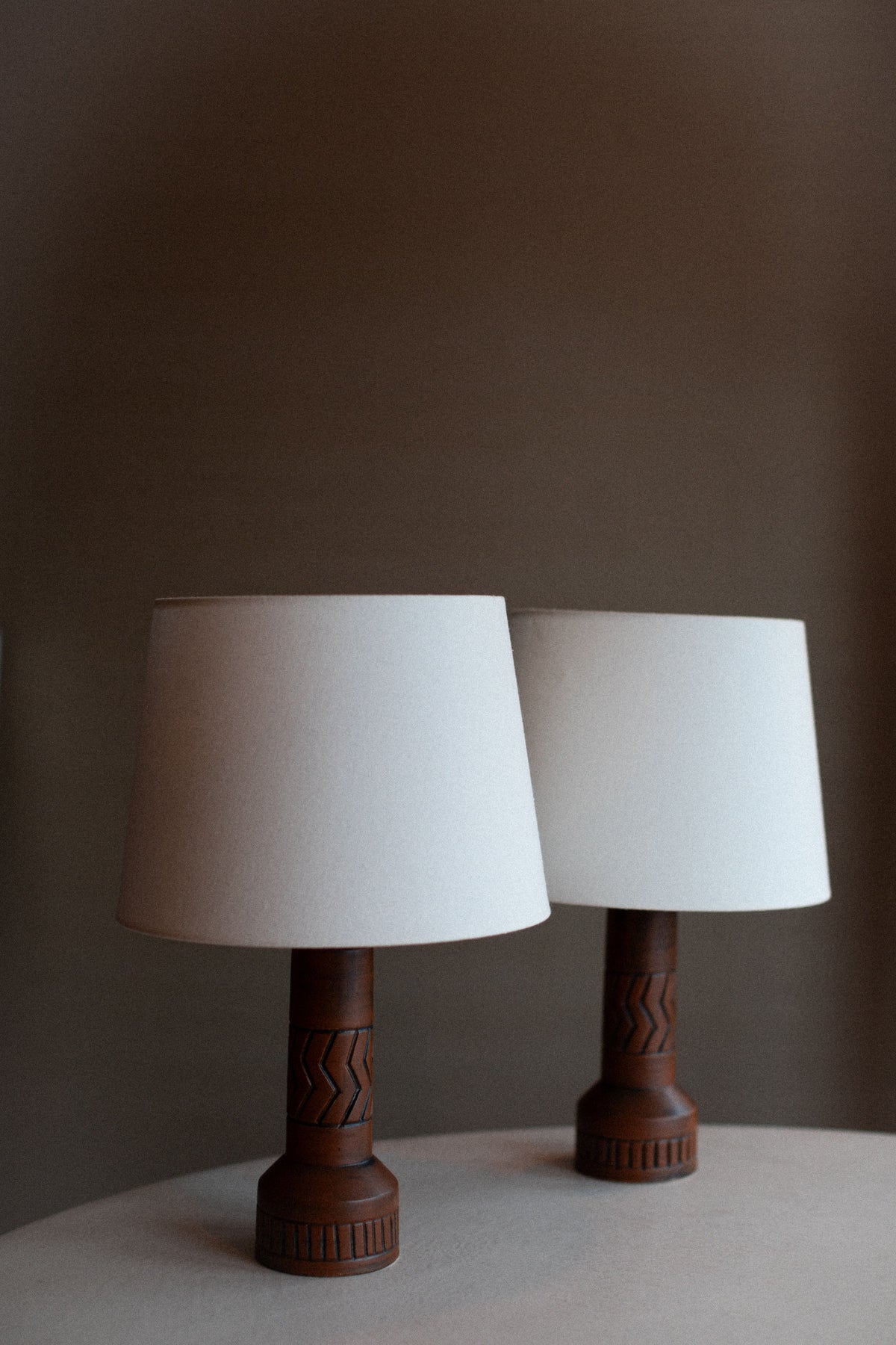 Tall vintage stoneware lamp with subtle speckled finish and brass accents