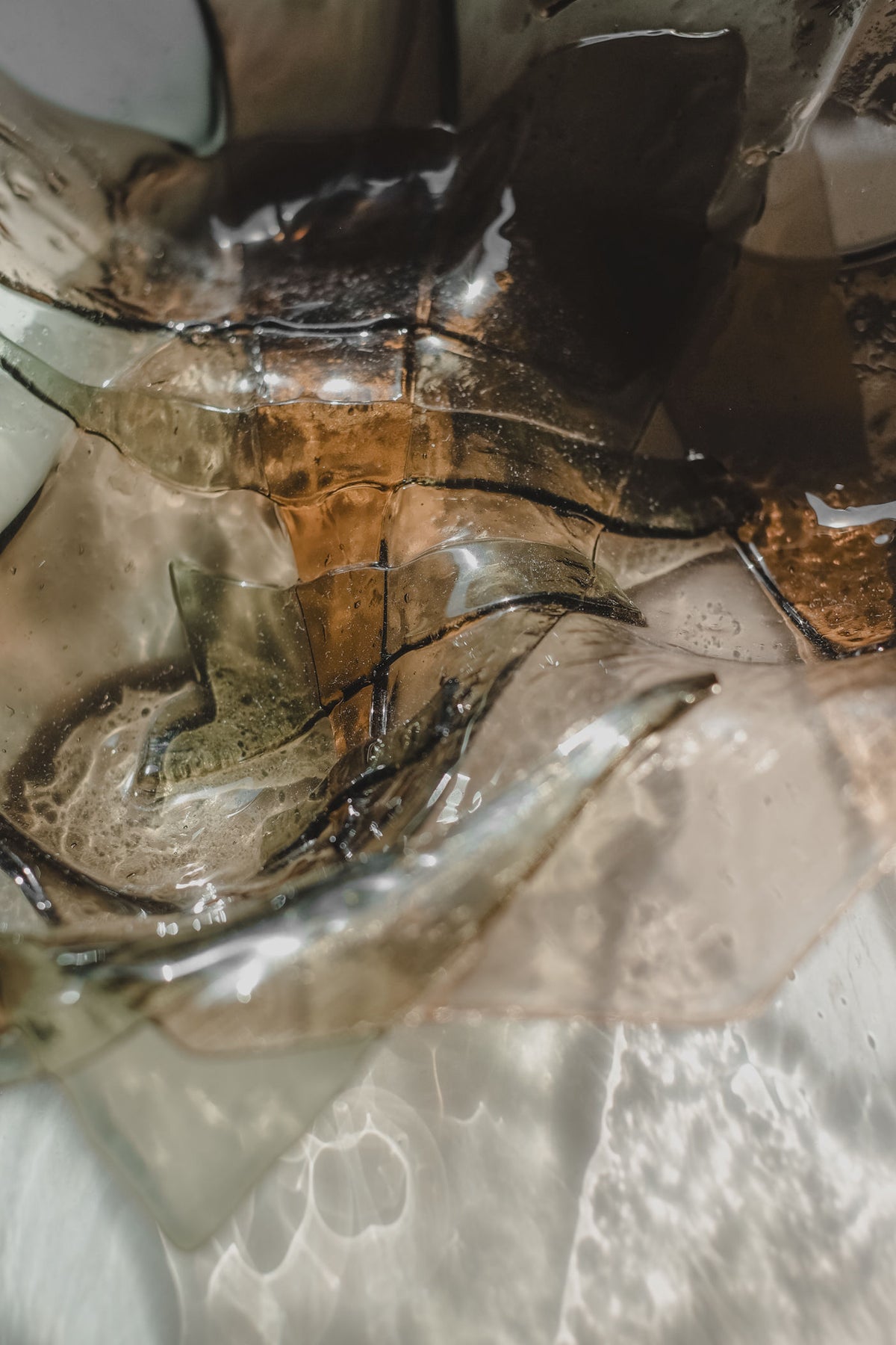 Amber-tinted handmade glass bowl with flowing organic curves