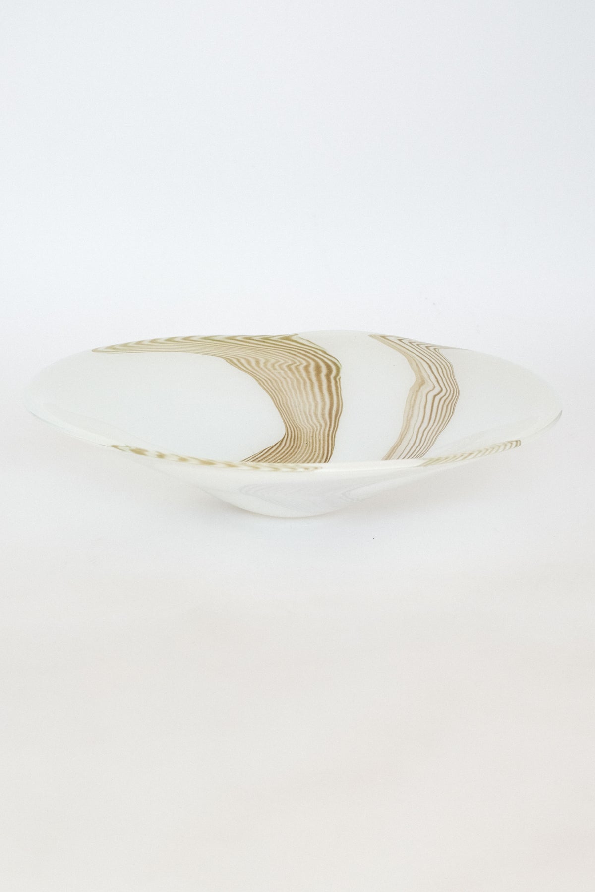 Large blown glass bowl with organic curves and layered wood grain pattern