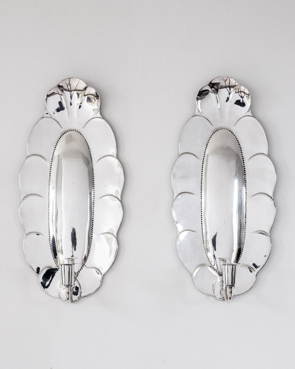 Pair of 1930s scalloped silver wall sconces with candle holders