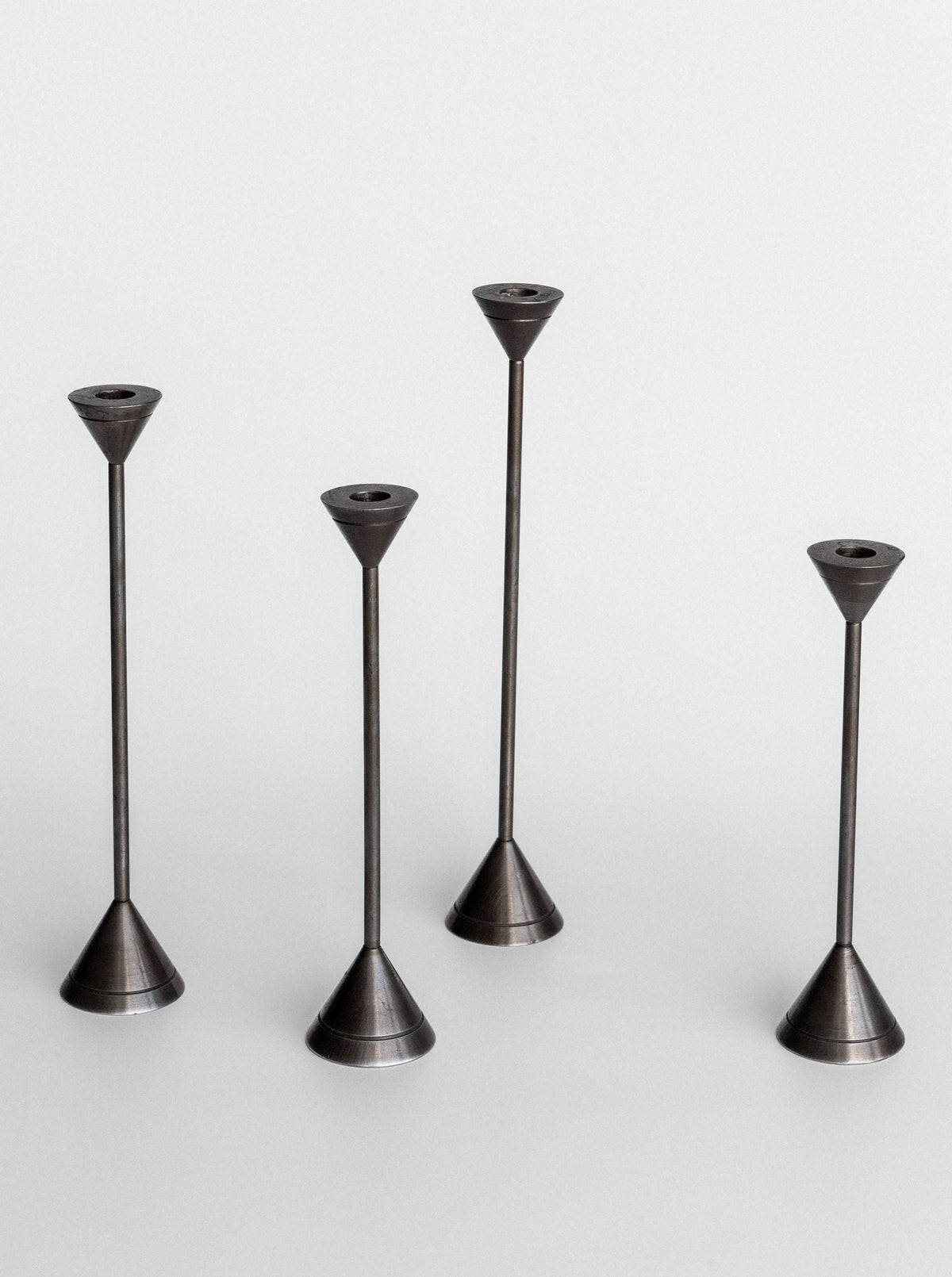 A group of stylish metal candle holders exuding a postmodern charm from Spigel's Set of Four Postmodern Candle Holders.