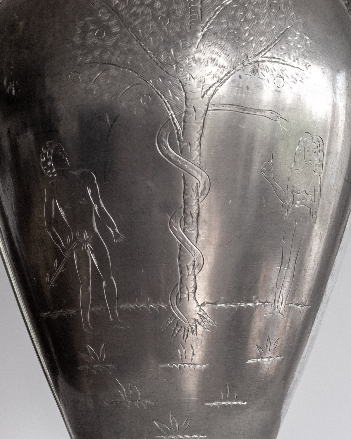 Detail view of engraved Adam and Eve scene on Swedish pewter vase