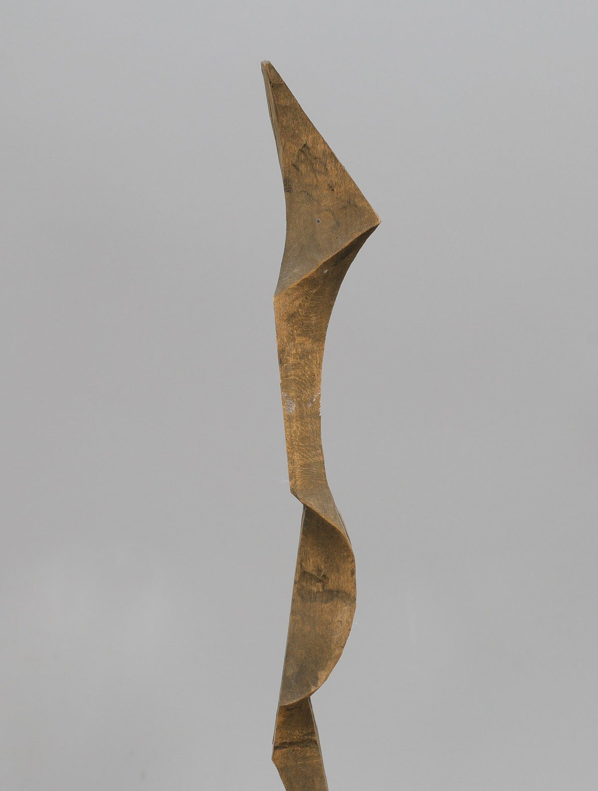 Twisting biomorphic wooden sculpture with angular geometric forms