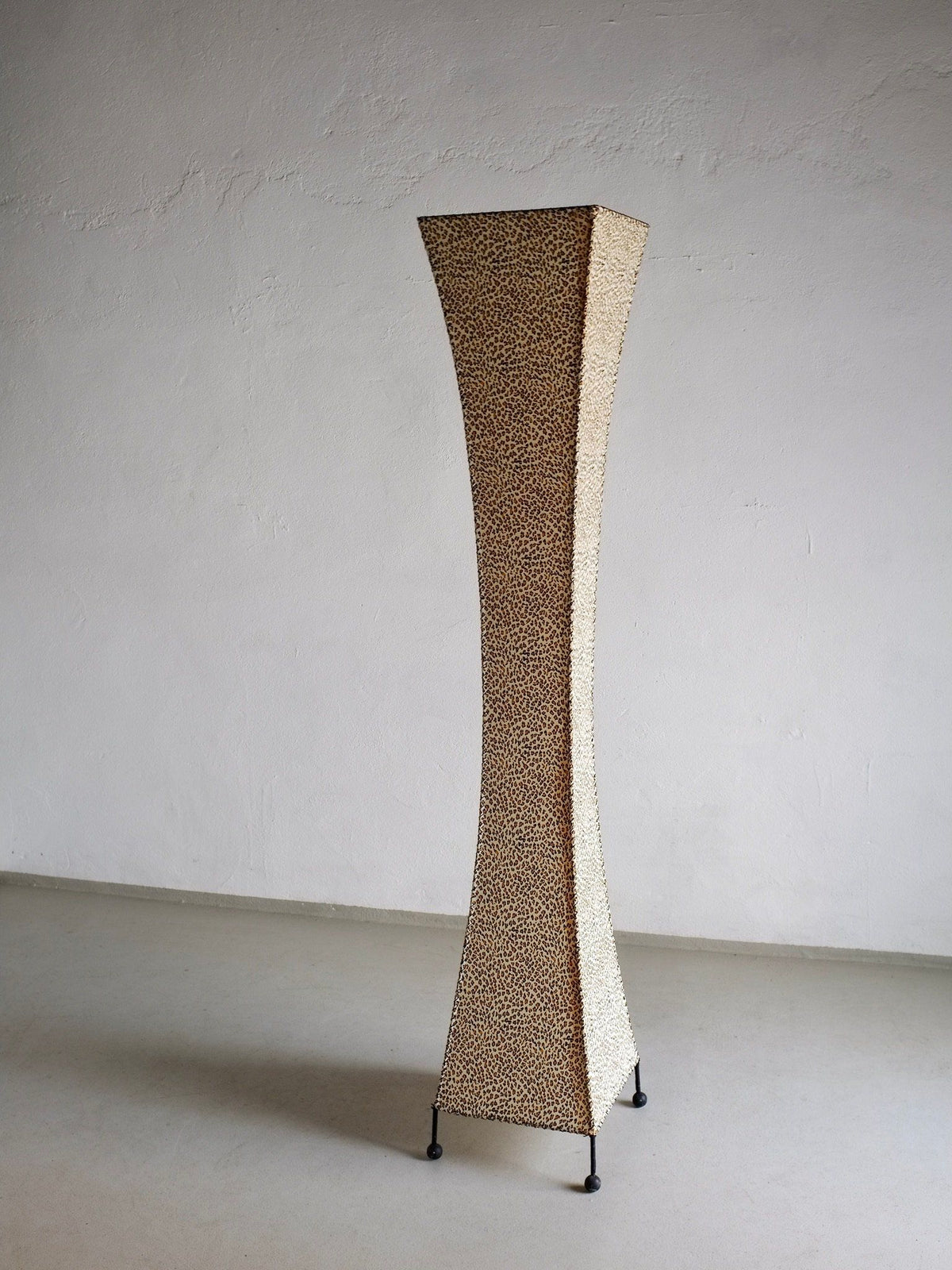 The Leopard Print Floor Lamp by Veter Vintage (1980s) features a tall, curved design with leopard print pattern and four small legs, shown against a plain white wall and light gray floor.
