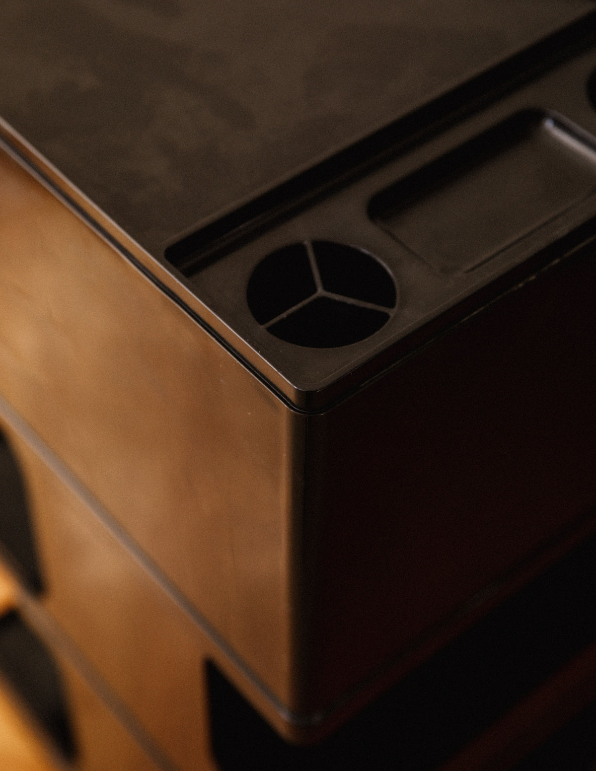 Storage trolley detail showing circular ventilation grille on top surface