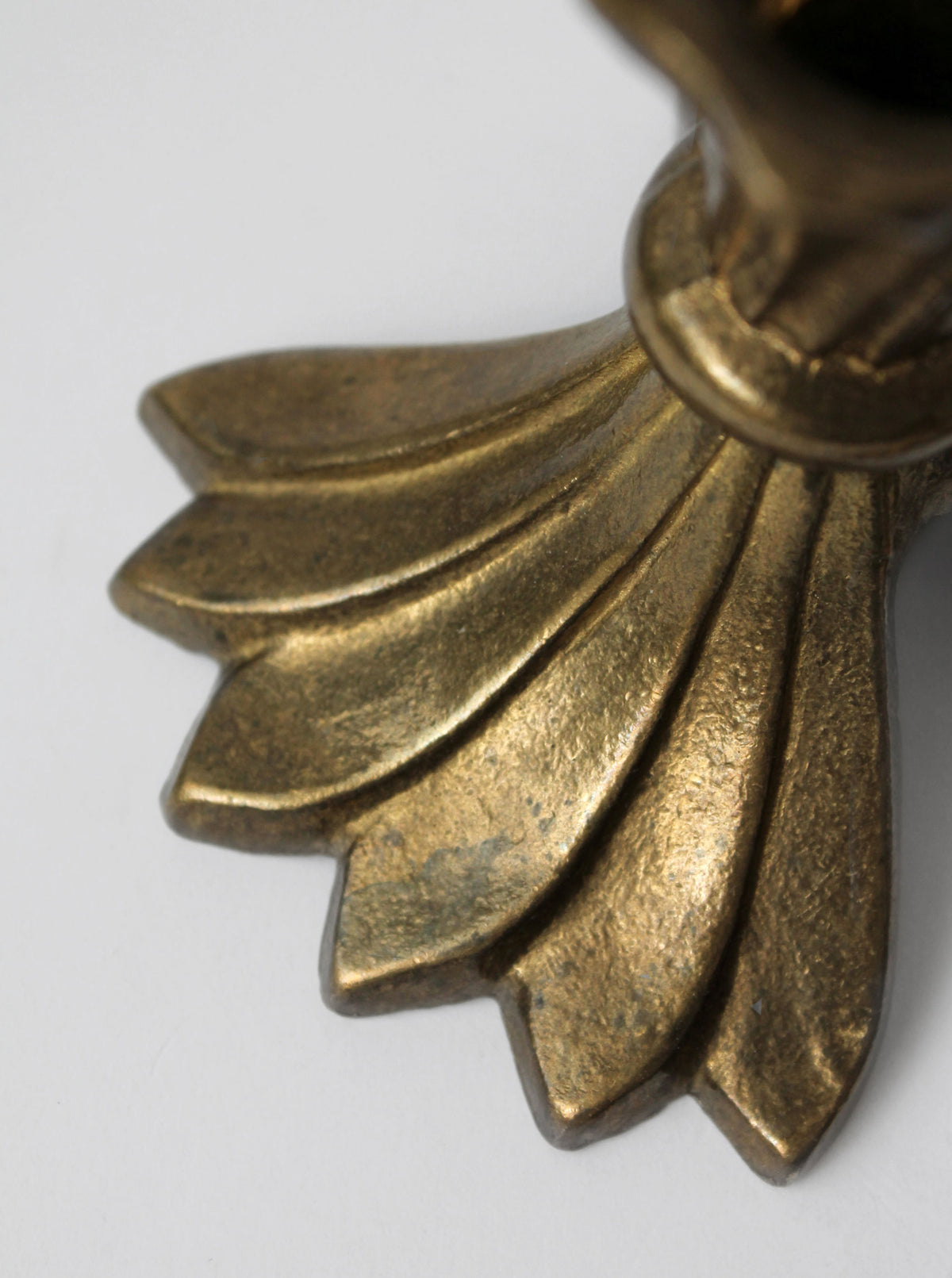 Ornate brass candle holder base with radiating petal design detail