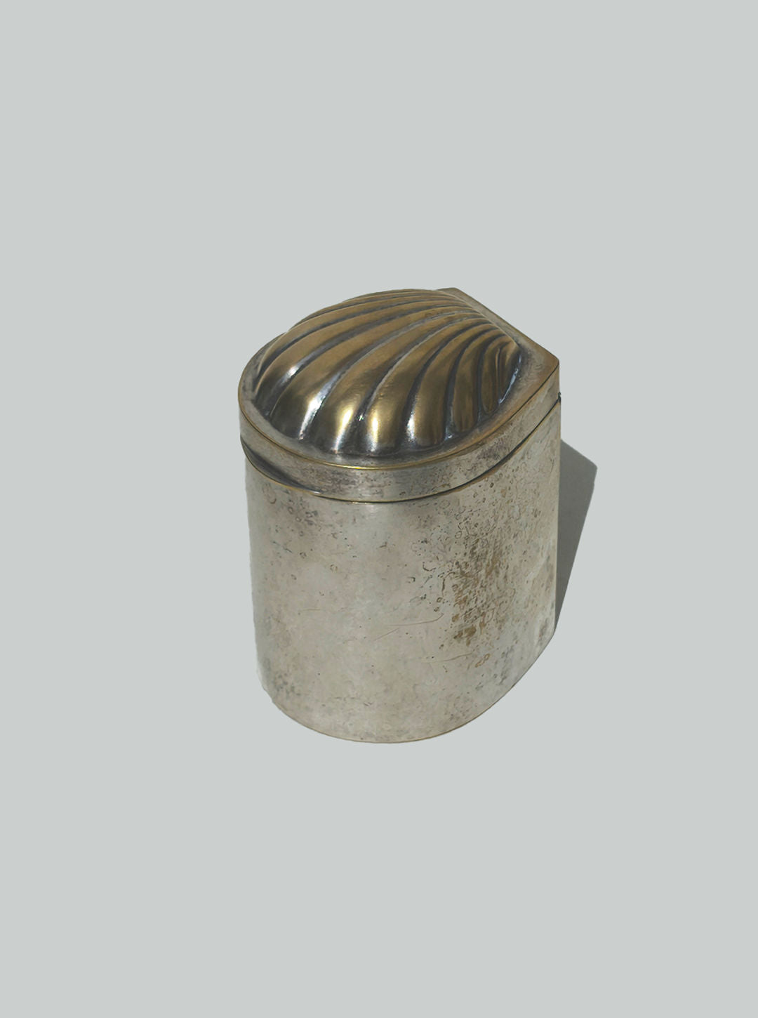 Shell-shaped lid detail of patina brass decorative box