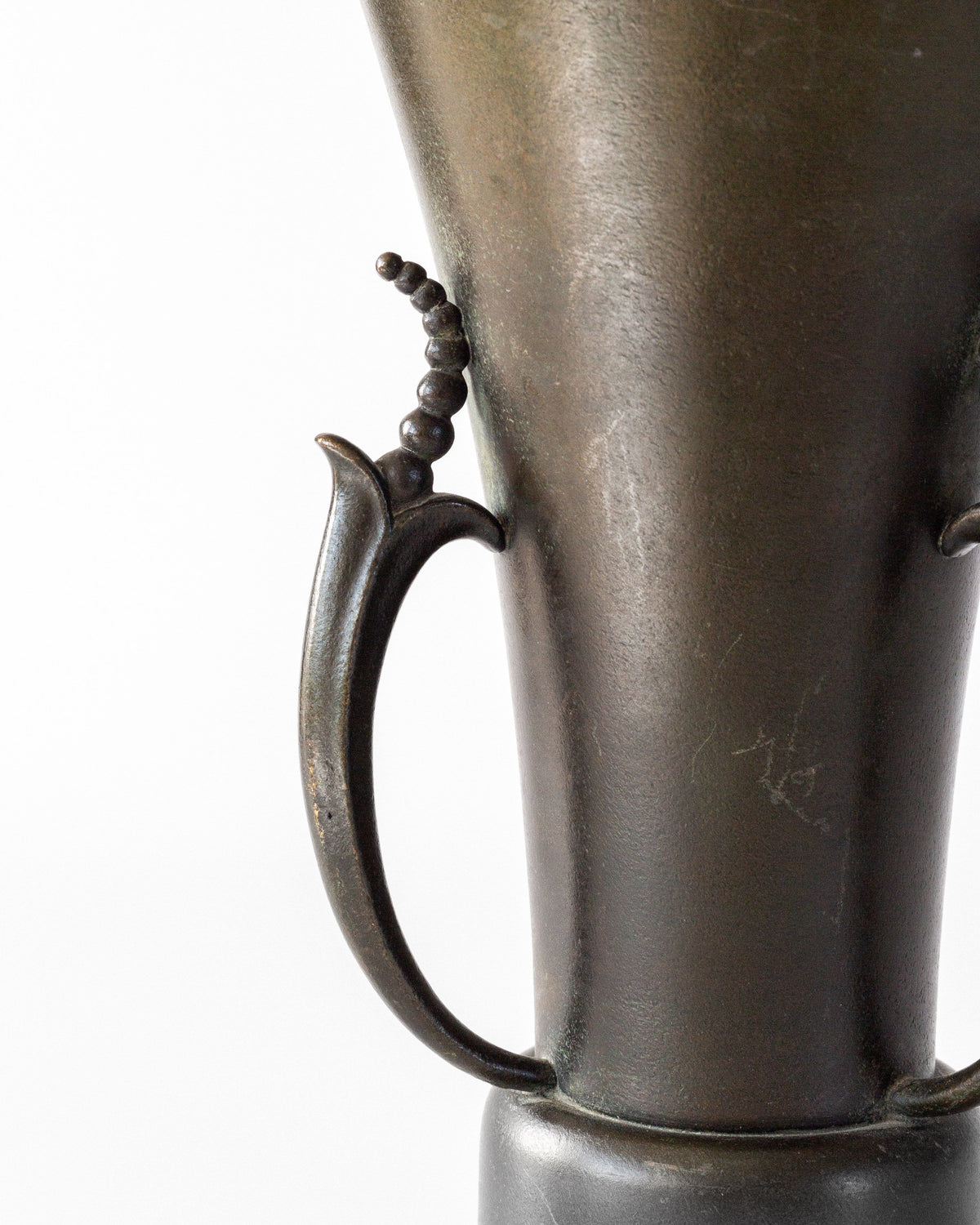 Handle detail of Grace bronze vase showing decorative beading