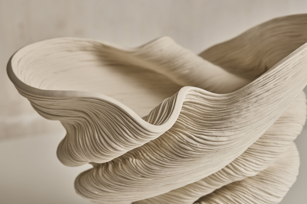 Flutter sculptural vase showing flowing organic curves and ridged texture